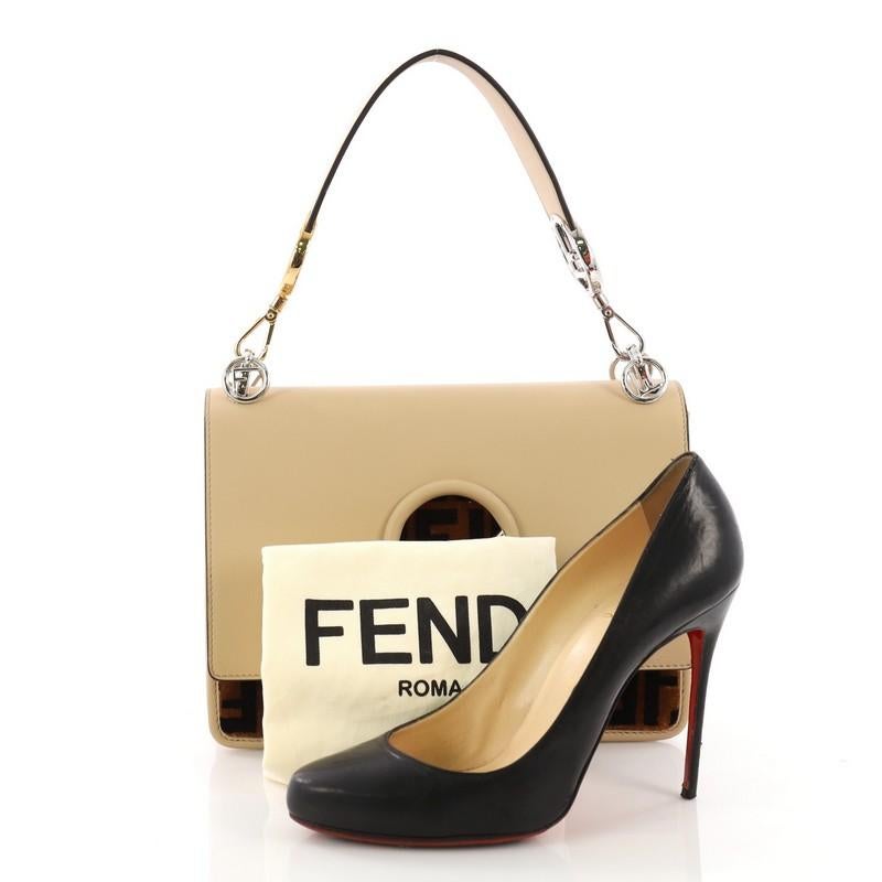 This Fendi Kan I F Shoulder Bag Leather with Zucca Velvet Medium, crafted from beige leather with zucca velvet, features a detachable flat leather top handle, Fendi logo, detachable shoulder strap, and silver-tone hardware. Its magnetic snap