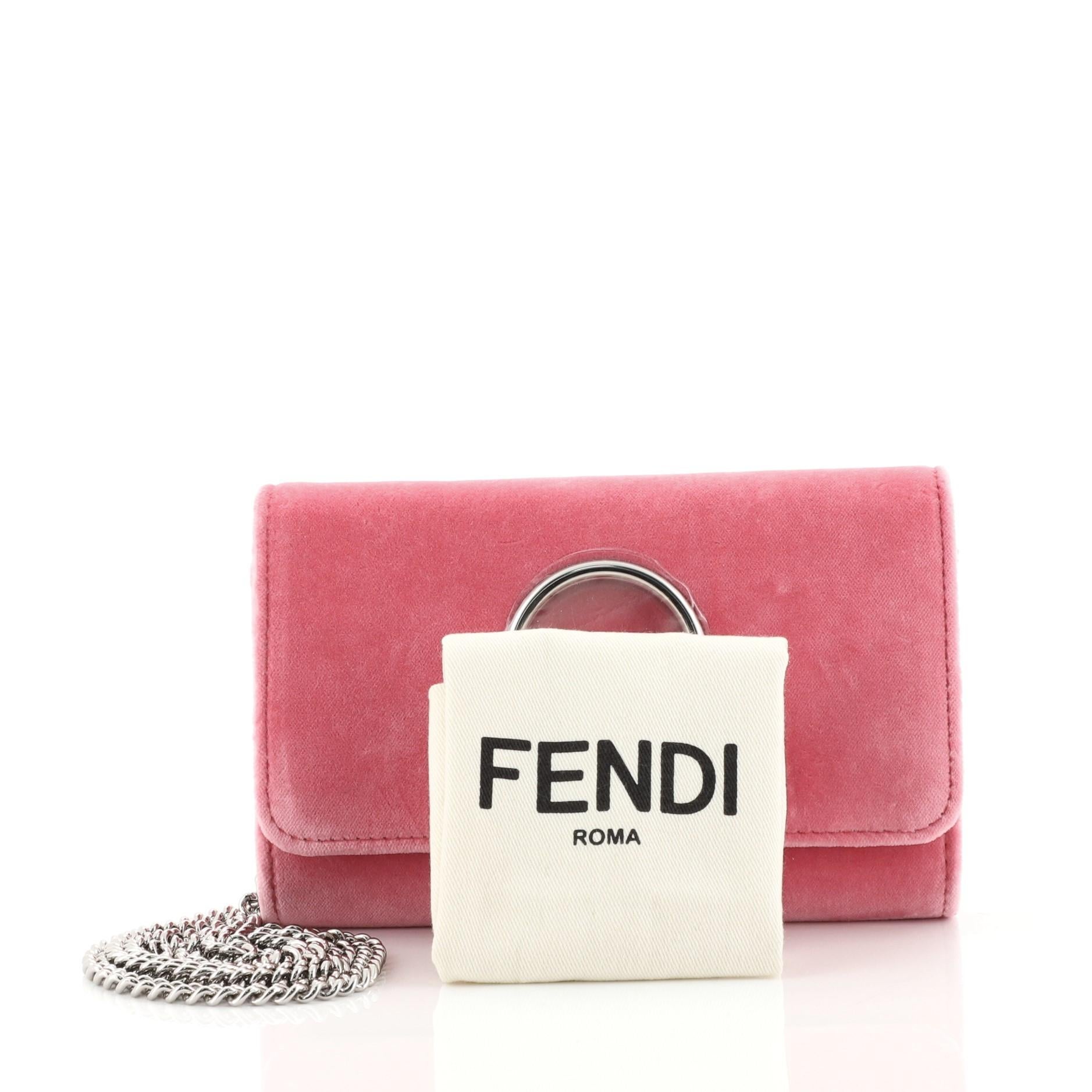 This Fendi Kan I F Wallet On Chain Velvet, crafted in pink velvet, features chain link strap, front flap, and silver-tone hardware. Its magnetic snap closure opens to a gray fabric interior with zip and slip pocket. 

Estimated Retail Price: