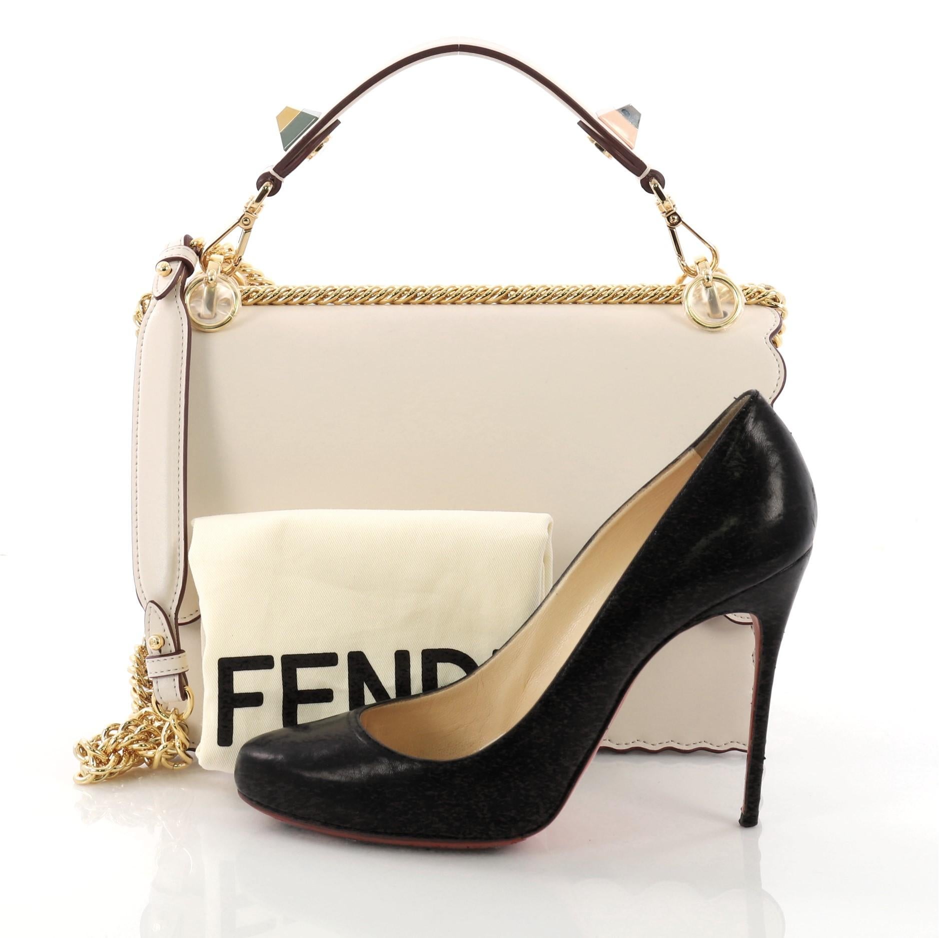 This Fendi Kan I Handbag Leather Medium, crafted from white leather with scalloped trims, features flat top handle with ABS studs, long sliding chain-link shoulder strap with leather insert, and gold-tone hardware. Its twist-lock closure opens to a