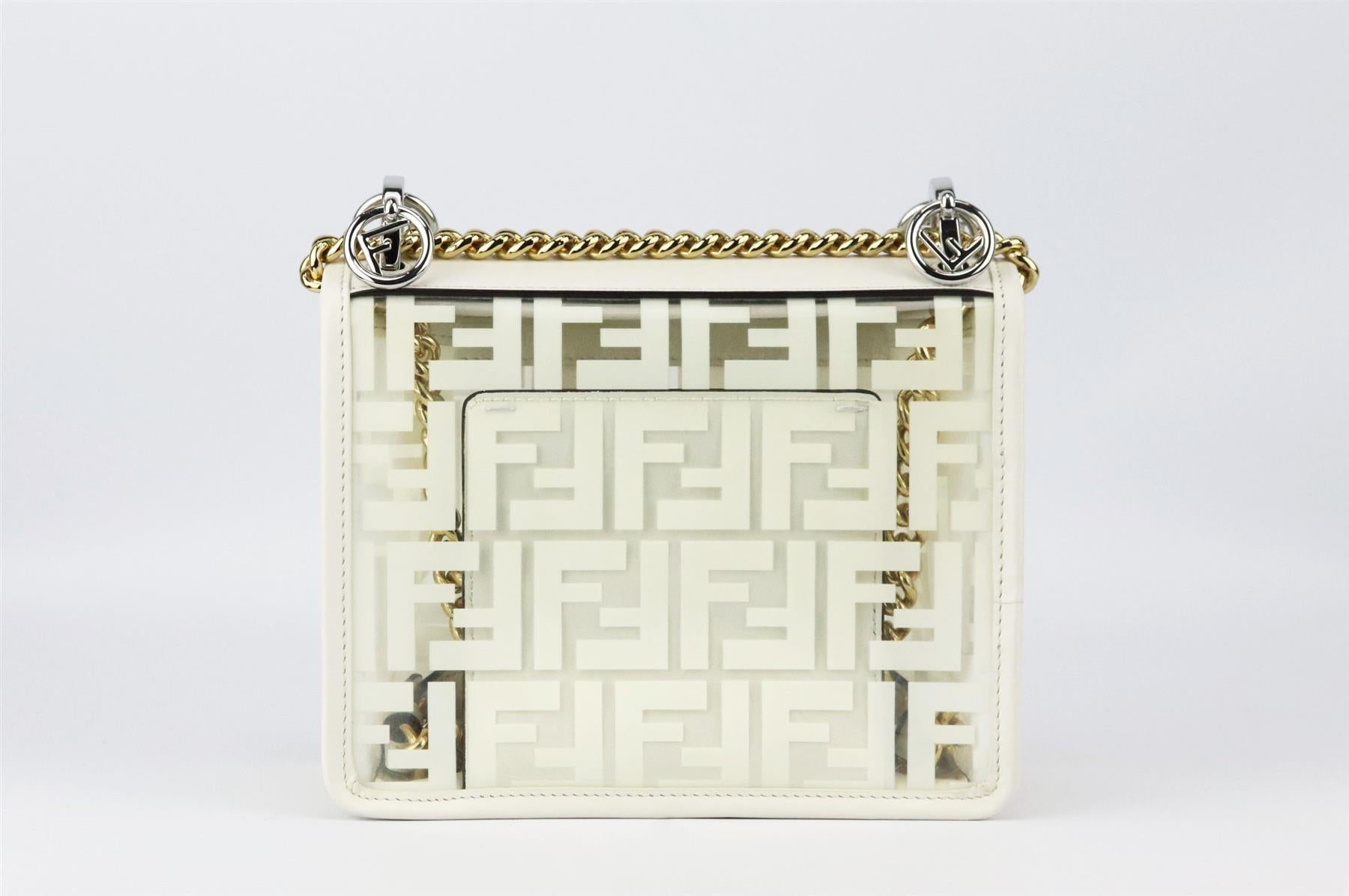 This small 'Kan I' bag by Fendi is made from smooth Italian leather and printed FF PVC and punctuated with glossy silver and gold hardware with chain shoulder strap, it opens to a spacious matching PVC interior with plenty of room for your daily