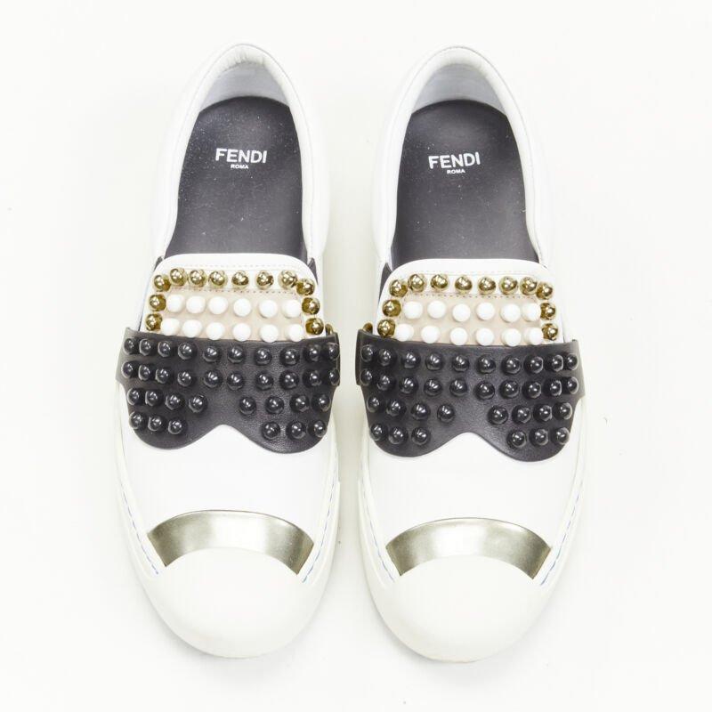 FENDI Karl Loves studded Karlito white leather skate sneakers EU36.5
Reference: ANWU/A00362
Brand: Fendi
Collection: Karl Loves
Material: Leather
Color: White, Multicolour
Pattern: Solid
Lining:  Leather
Extra Details: Abstract Karlito face design
