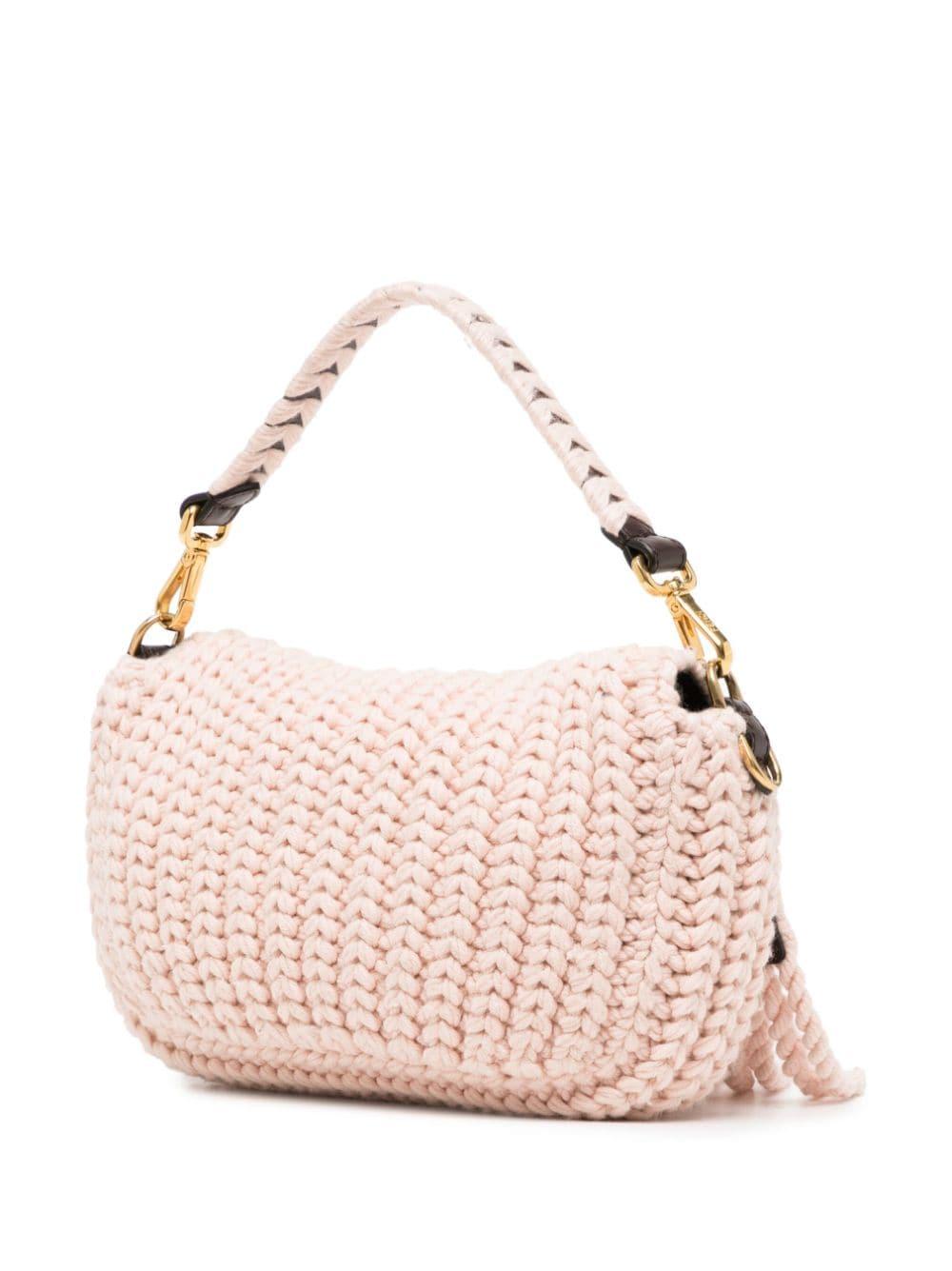 * Light pink
* Wool
* Crochet knit
* FF logo plaque
* Foldover top
* Single detachable top handle & shoulder strap
* Internal zip-fastening pocket
* Internal logo plaque
* Logo-print lining
* Gold-tone hardware
* Excellent Condition: comes with a