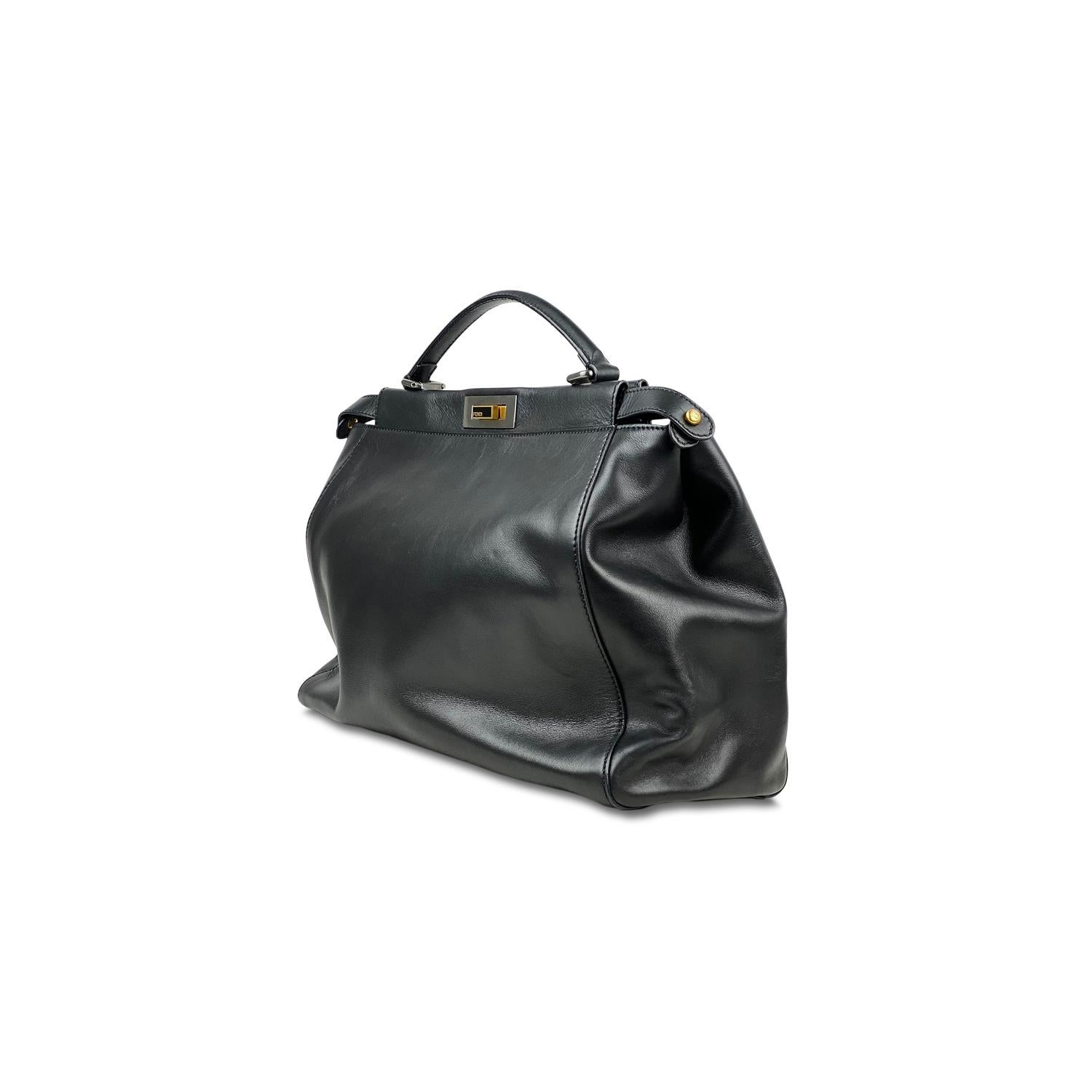 Black leather Fendi Large Peekaboo tote with

– Multi-tonal hardware,
– Single flat shoulder strap
– Single flat top handle
– Dual interior compartments, black suede lining, single interior zip pocket and dual turn-lock closures at top

Overall