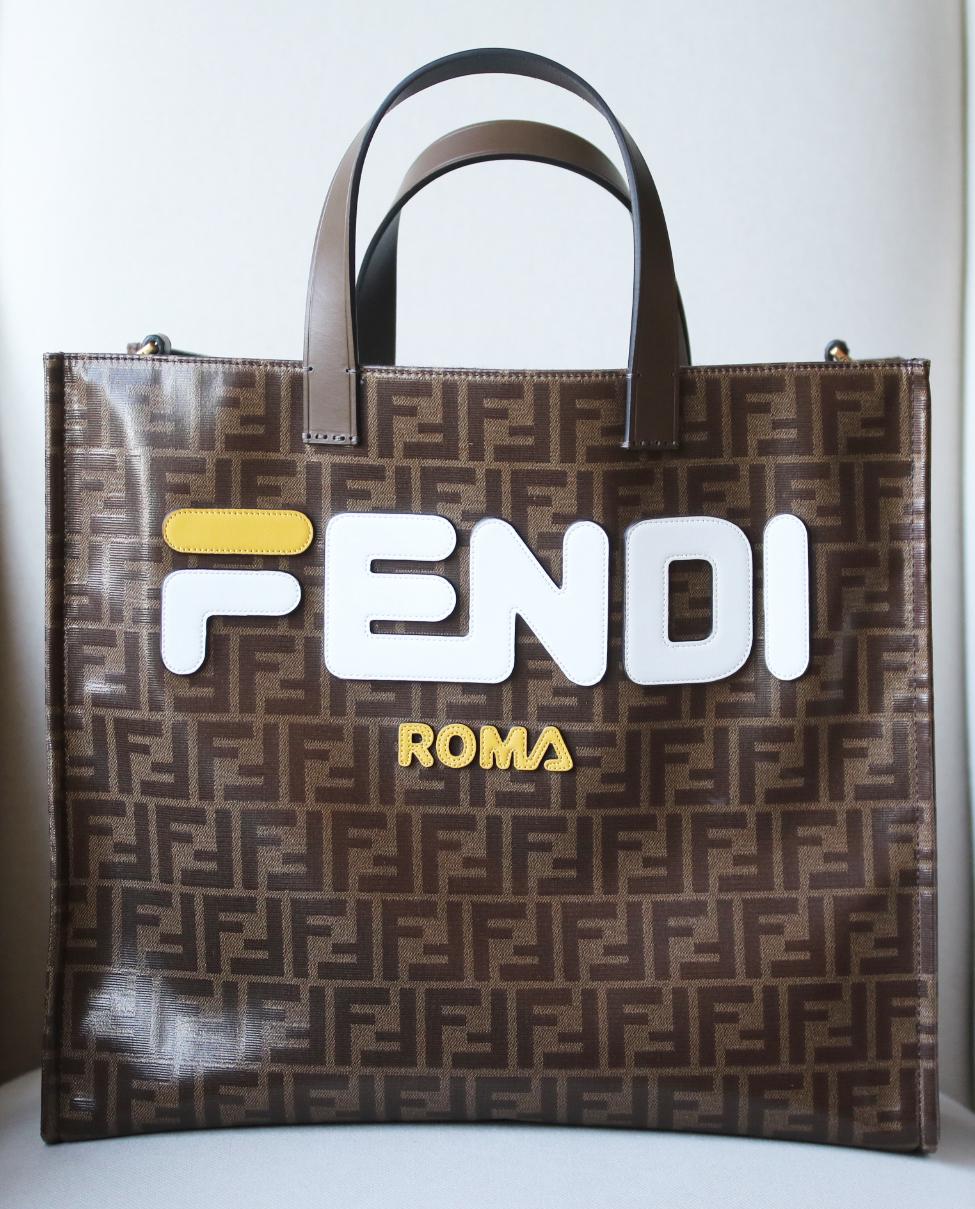 This tote has been made in Italy from coated-canvas appliquéd with a Fila-inspired logo. It's roomy enough for a tablet and all of your weekly essentials and is finished with a zipped pocket to keep things organized. Tonal-brown coated-canvas, navy,