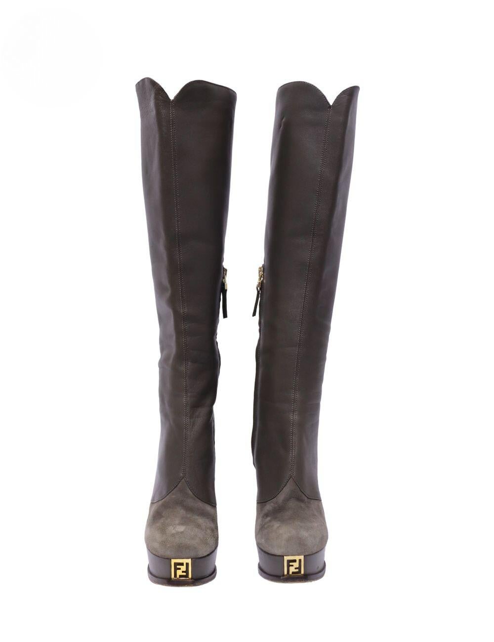 Fendi Leather Knee Length Boots , Features a Semi Round-toe, Platform and an FF Logo Plaque. 

Material: Leather and Suede
Size: EU 36
Heel Height: 13.5cm
Platform Height: 3cm
Overall Condition: Good
Interior Condition: Signs of use
Exterior