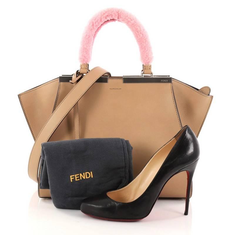 This authentic Fendi 3Jours Handbag Leather with Shearling Petite is an impeccably stylish update from its popular predecessor the 2Jour tote. Crafted from nude leather, this tote features the popular side wings, shining silver-tone split top bar