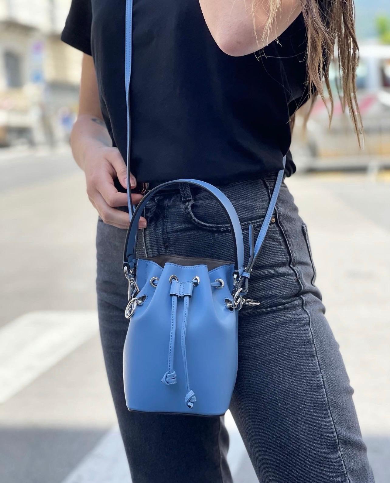 Fendi designer bag, bucket size, made of smooth light blue leather with silver hardware. Closure with laces, internally capacious for the essentials. Equipped with top handle and removable shoulder strap. The bag is in excellent condition, current