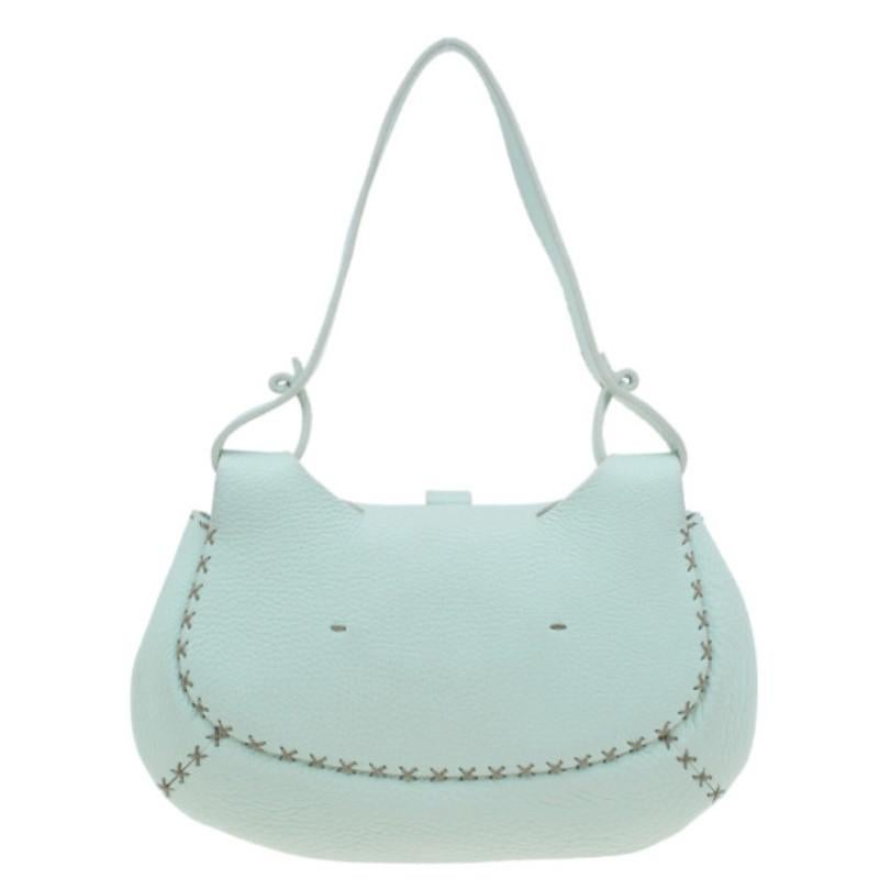This light green hobo from Fendi is versatile and will pair well with any color. Made from superior leather, the exterior features distinctive cross stitching detail in contrast color, leather trim, a buckle detailed top flap and a single sleek
