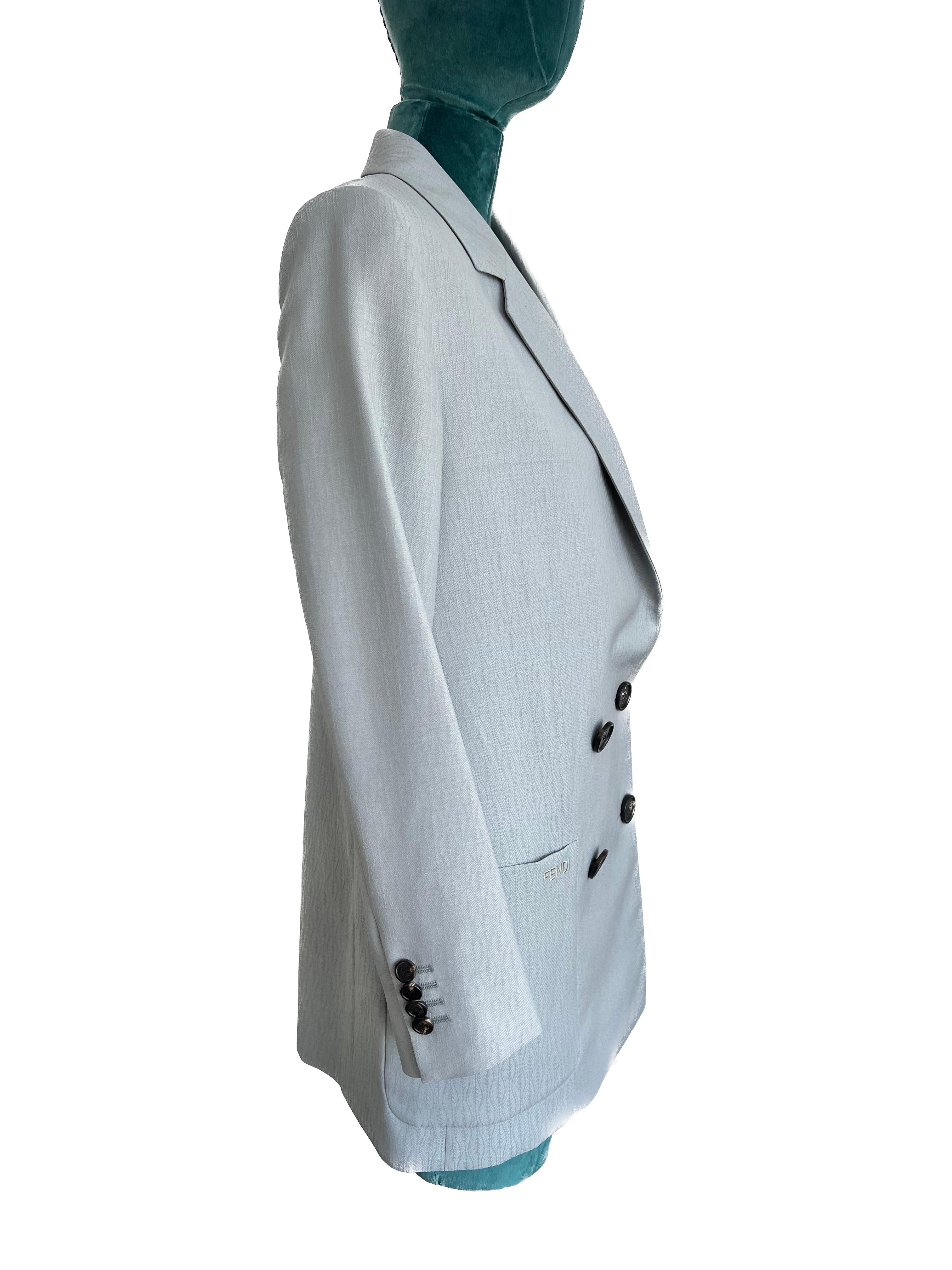 Elevate your style with the Fendi Light Grey Double Breasted Blazer, a stunning piece that seamlessly blends sophistication with modern flair. Impeccably designed and brand new with tags, this blazer exudes luxury and attention to detail. The light