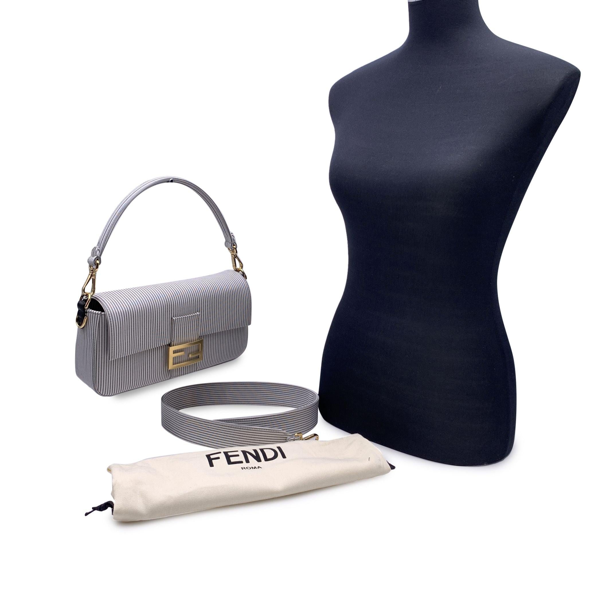 This beautiful Bag will come with a Certificate of Authenticity provided by Entrupy, The certificate will be provided at no further cost. Gorgeous FENDI 'Bretagna Baguette' bag in striped cotton in grey and white with black leather trim . A simple