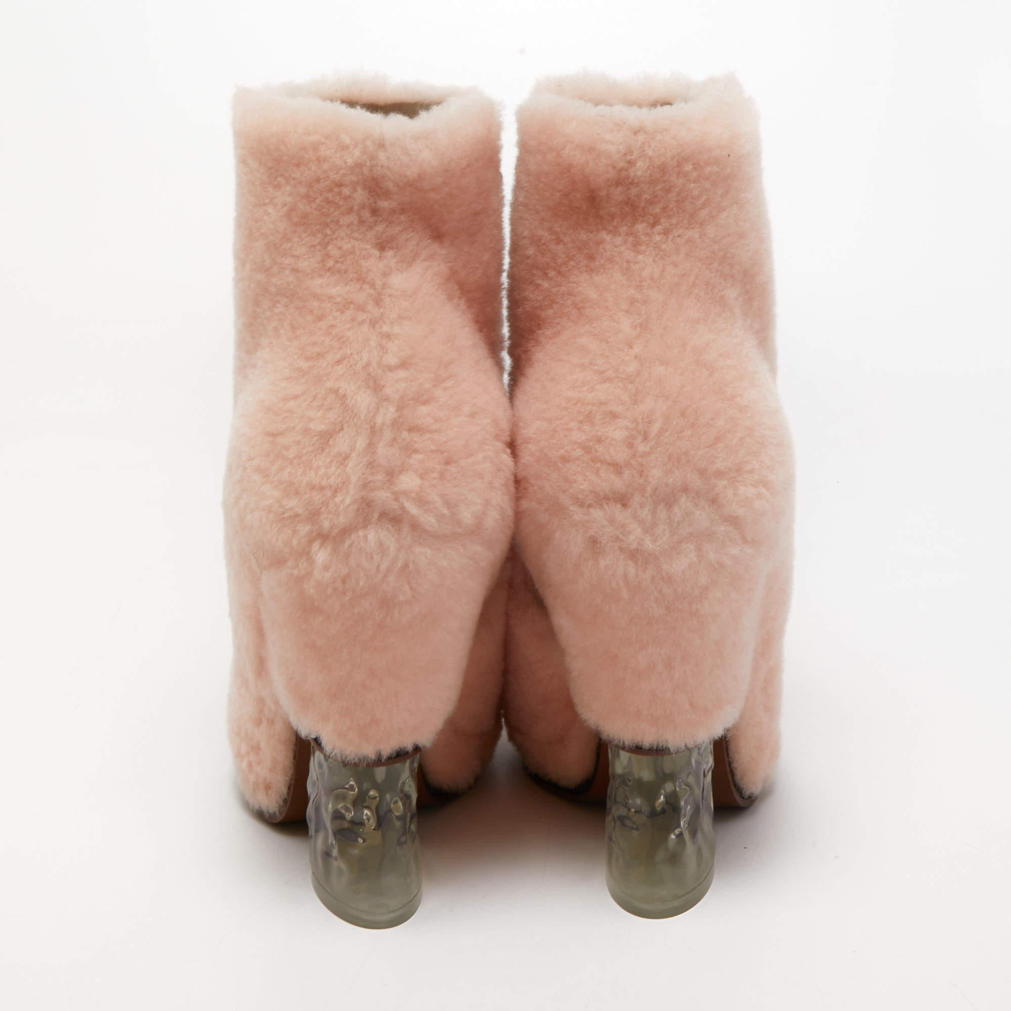 Fendi is all set to impress you with this stunning pair of boots. Crafted from shearling, they feature sturdy heels. This pair of boots will raise your style factor.

Includes: Original Box
