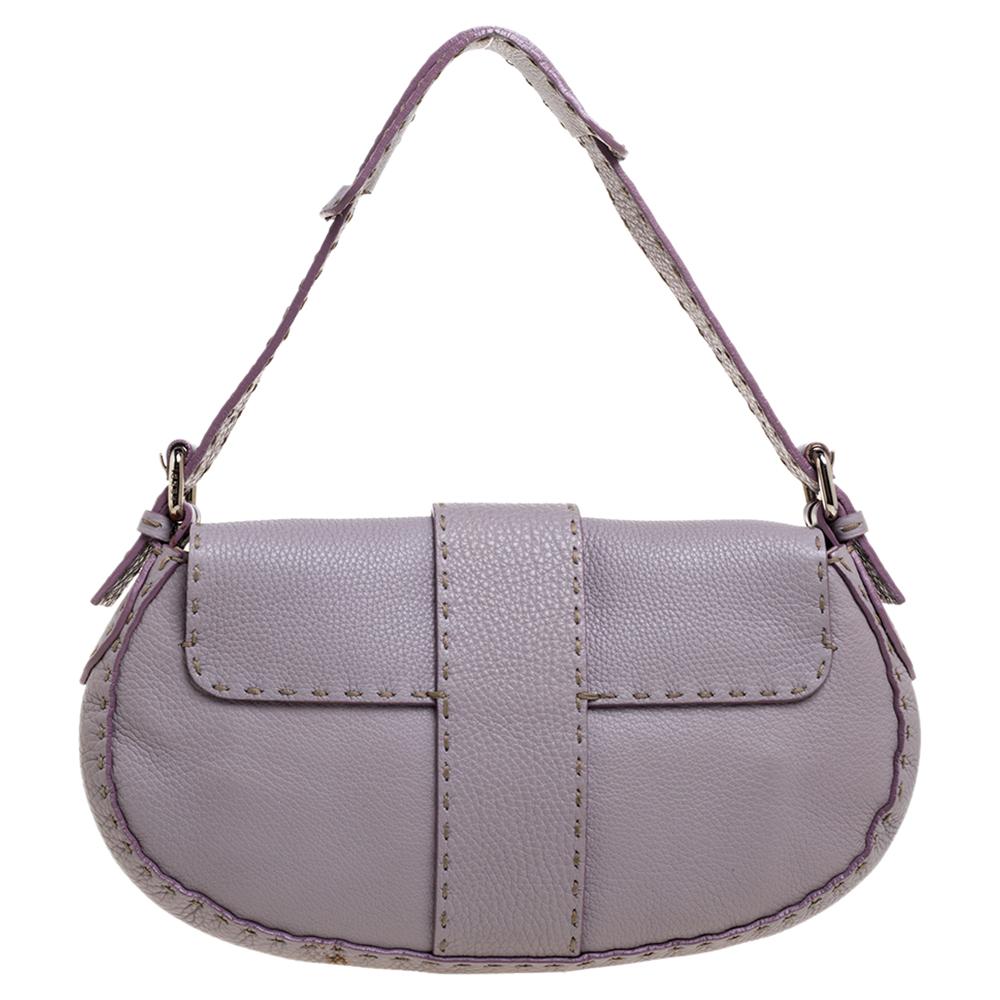 This Fendi creation is crafted from lilac-hued leather featuring a silver-tone brand logo at the front. This Selleria shoulder bag is designed with a flap closure that opens to a well-sized suede interior. A classic piece of luxury to fill your