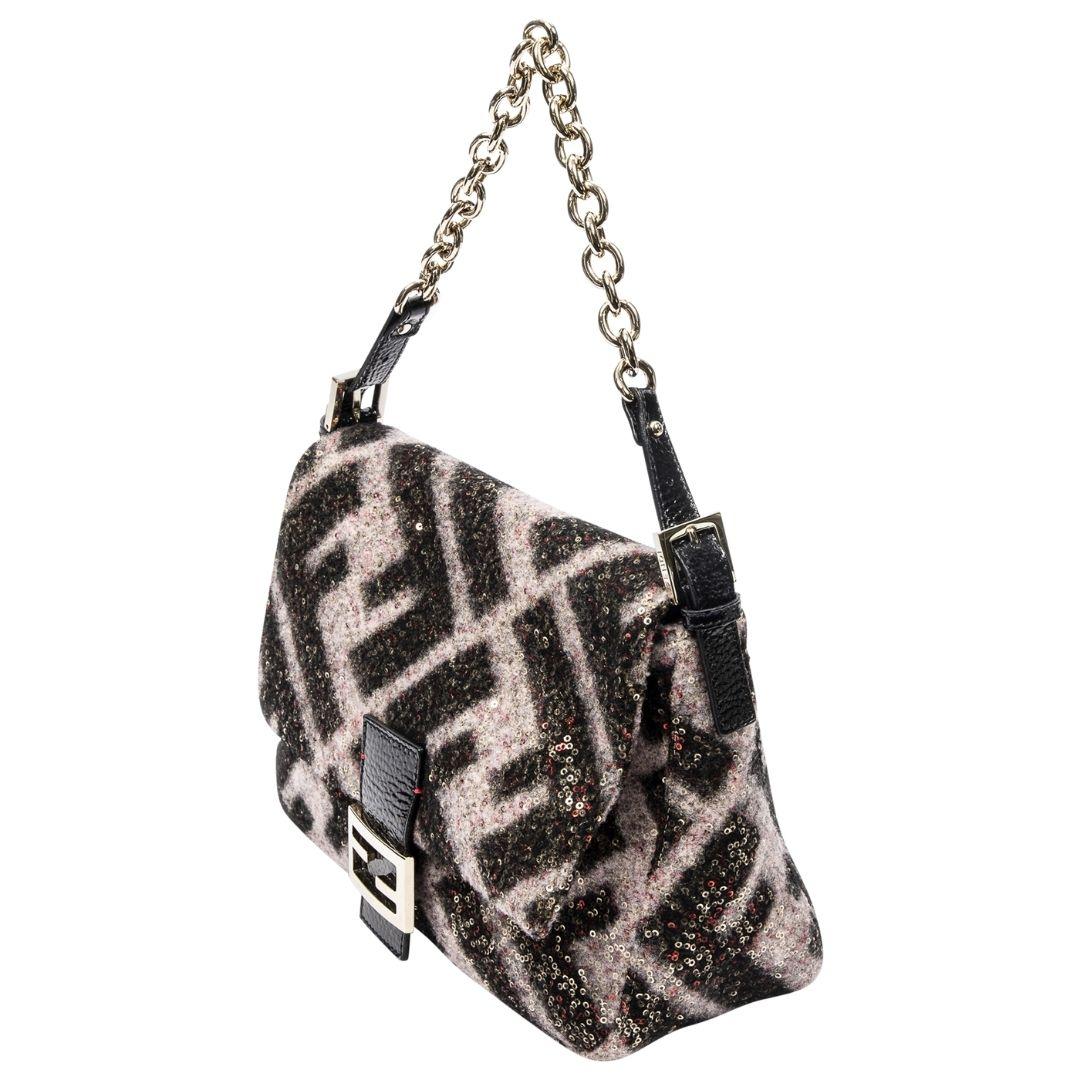 Fendi's Sequin Mama Baguette dazzles in a black/rose sequin leather with rose gold hardware. Its magnetic snap opens to a jacquard-lined interior featuring one zippered pocket for essentials.

SPECIFICS
• Length: 11.4