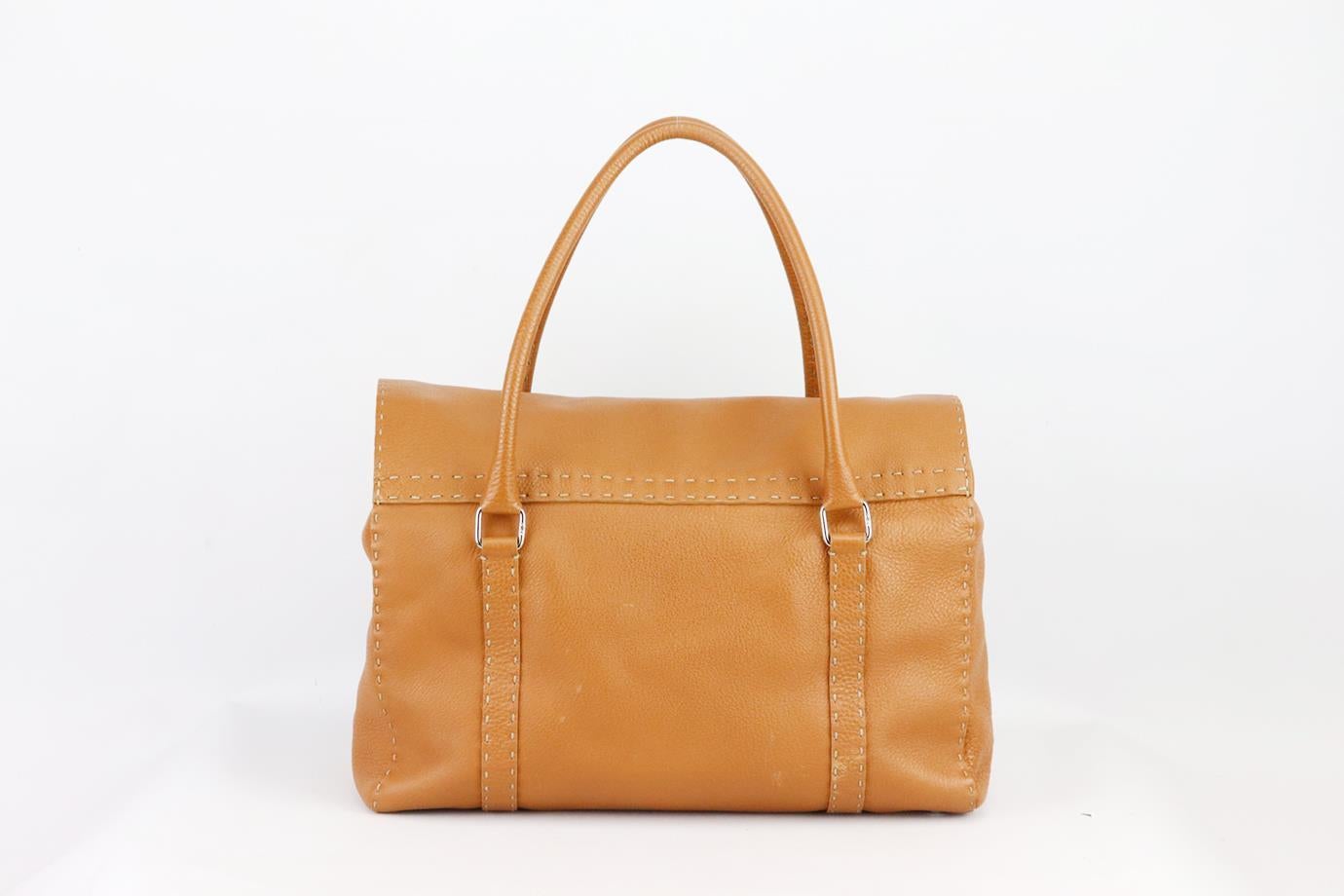 Fendi Linda Selleria large textured leather shoulder bag. Made from tan textured-leather with contrast stitching and buckle detail on the front, it has a large interior compartment with zipped pocket. Tan. Magnetic fastening at front. Does not come