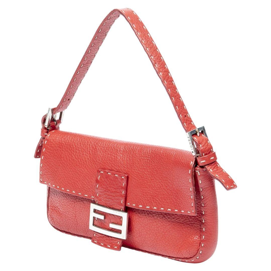 This bold Lipstick Red Fendi Baguette, crafted from Selleria leather with silver hardware, offers a magnetic snap closure. The satin-lined interior houses one zippered pocket, adding a splash of luxury to any ensemble.

SPECIFICS
• Length: 10.6