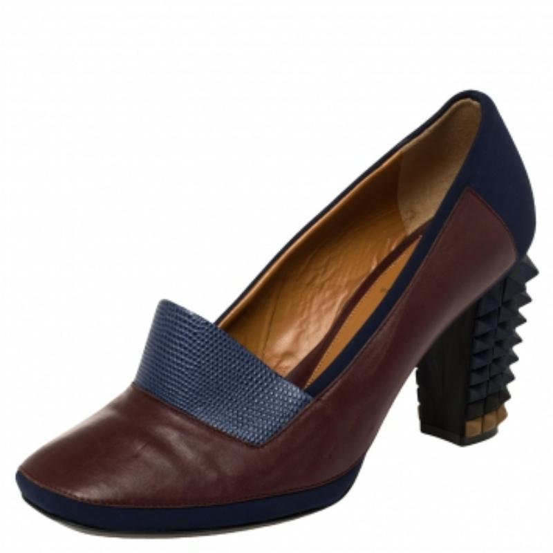 Ditch those boring pairs of stilettos and opt for these fashion-forward pumps from the house of Fendi. Complete any on-trend look with this quirky pair that features a lizard-embossed leather and fabric body. The thick, studded heel is marked as the