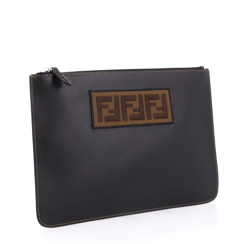 This Fendi Logo Pouch Leather Medium, crafted from black leather, features silver-tone hardware. Its zip closure opens to a black fabric interior. 

Estimated Retail Price: $750
Condition: Excellent. Small indentations on exterior, scratches on