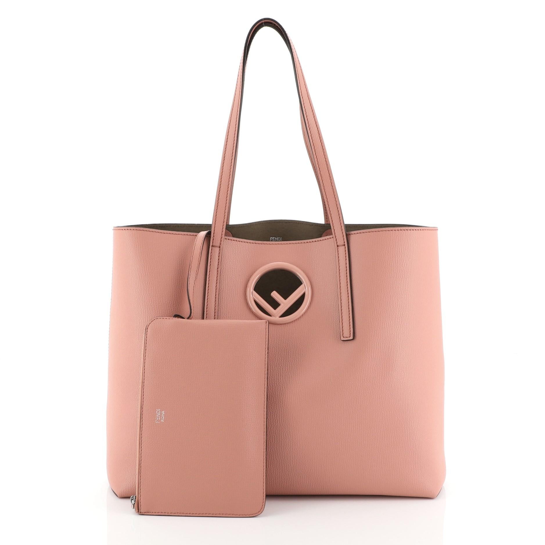 This Fendi Logo Shopper Tote Leather, crafted from pink leather, features dual flat leather handles, Fendi logo inset at front, and silver-tone hardware. It opens to a neutral suede interior. 

Estimated Retail Price: $1,300
Condition: Excellent.