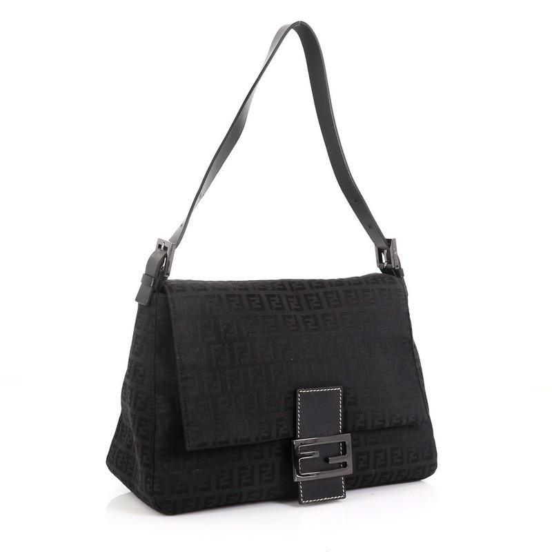 This Fendi Mama Forever Bag Zucchino Canvas, crafted from black Zucchino canvas, features an adjustable leather strap, Fendi hardware detailing, and gunmetal-tone hardware. Its hidden magnetic snap closure opens to a black fabric interior with side