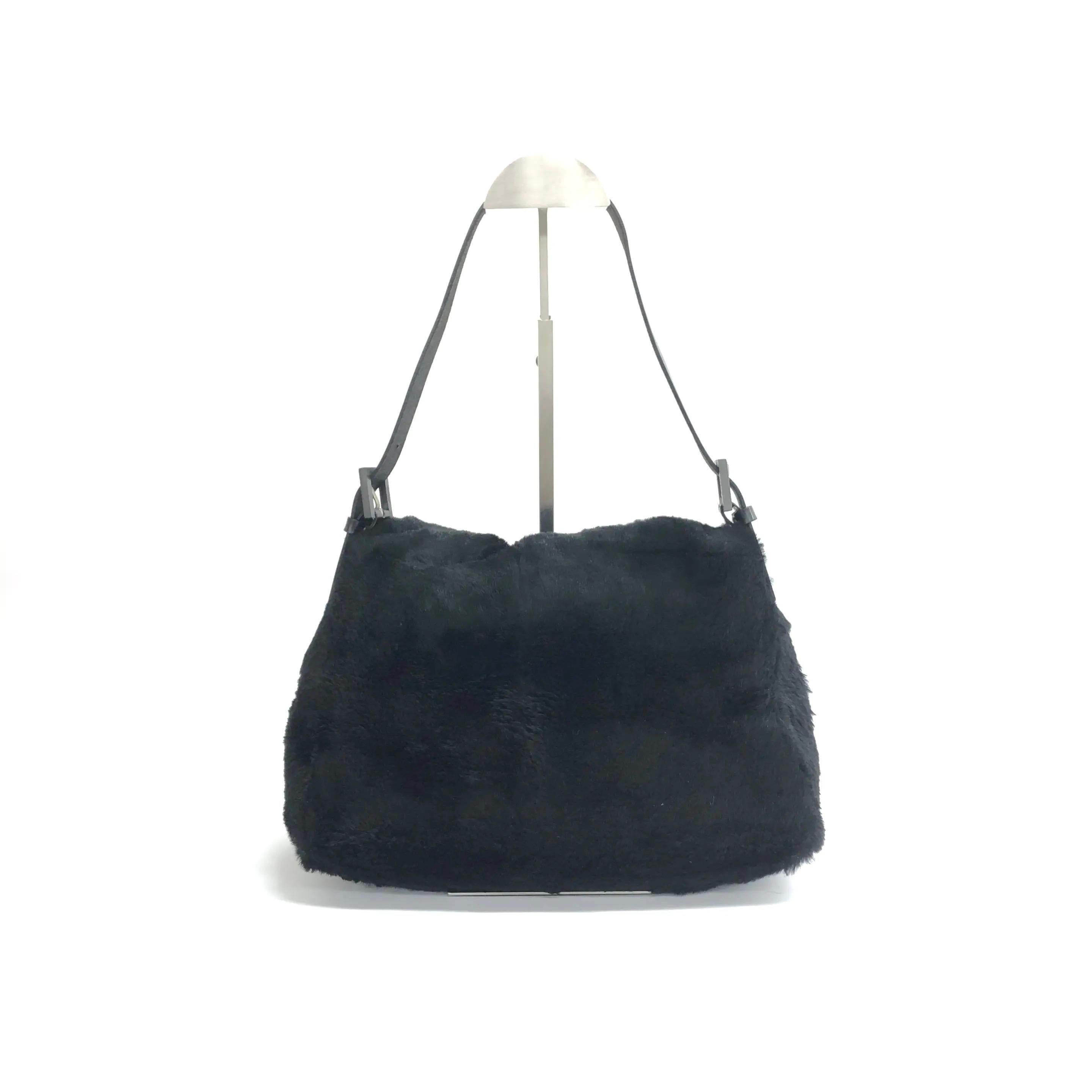 Fendi Mamma Baguette Black Faux Fur Shoulder Bag
These are professional photos of the actual bag offered by Luxbags.
This Fendi Baguette is both a handbag and a plush toy. Its touch is soft and it is highly lovable, making this piece extra
