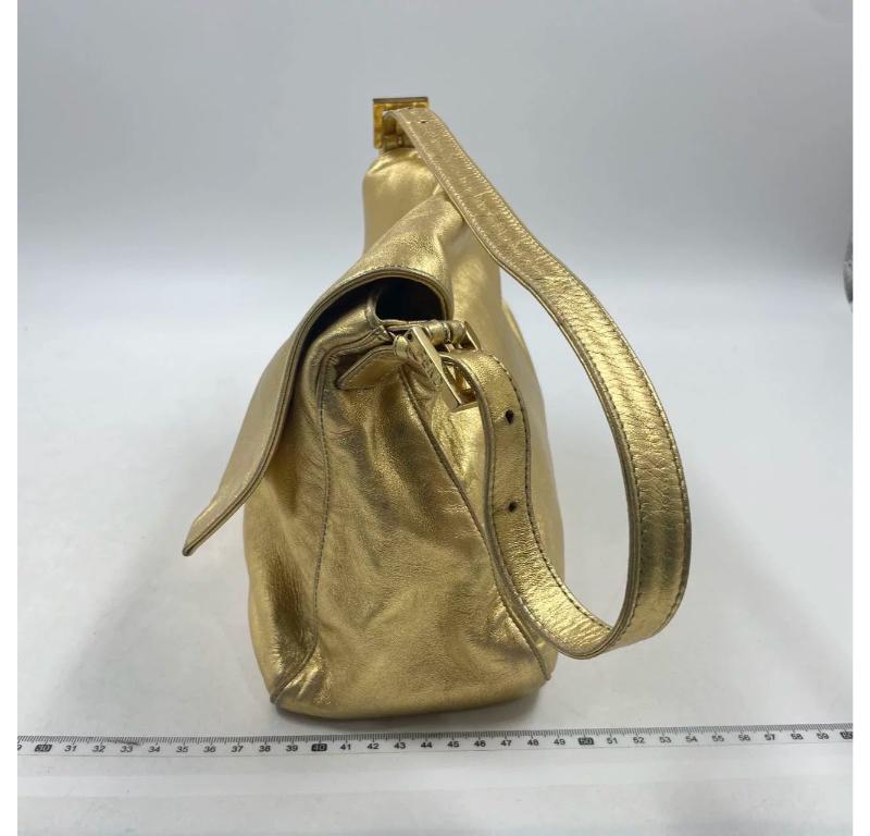 Fendi Mamma Baguette Gold Lambskin Leather Crystal Buckle
These are professional photos of the actual bag.
  This exquisite Fendi Mamma Baguette is expertly crafted from premium lambskin leather, providing a luxuriously soft and lightweight feel.