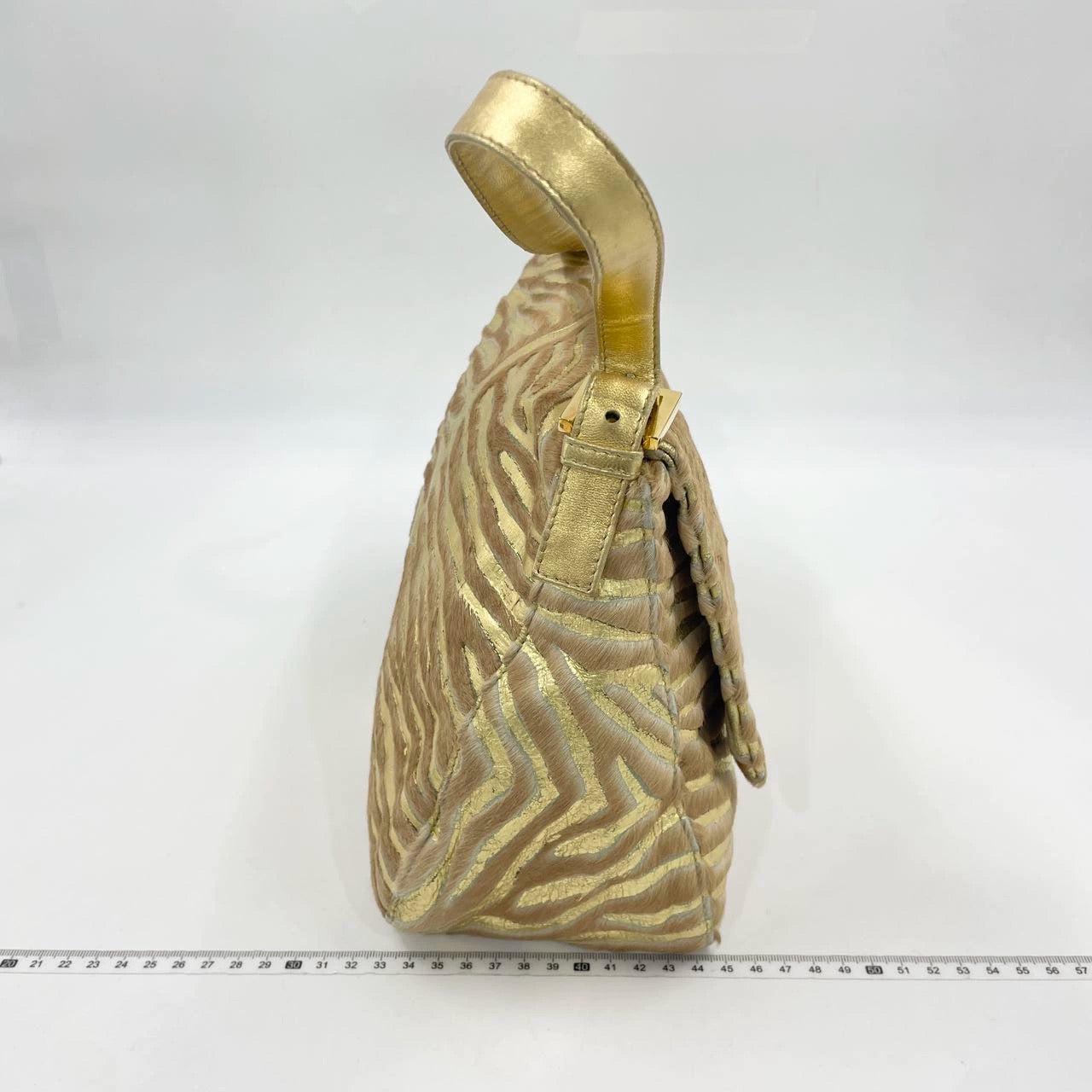 Fendi Mamma Baguette Gold Lambskin Leather Pony-style Zebra Stripes
 These are professional photos of the actual bag.
 This exquisite Fendi Mamma Baguette is expertly crafted from premium lambskin leather, providing a luxuriously soft and