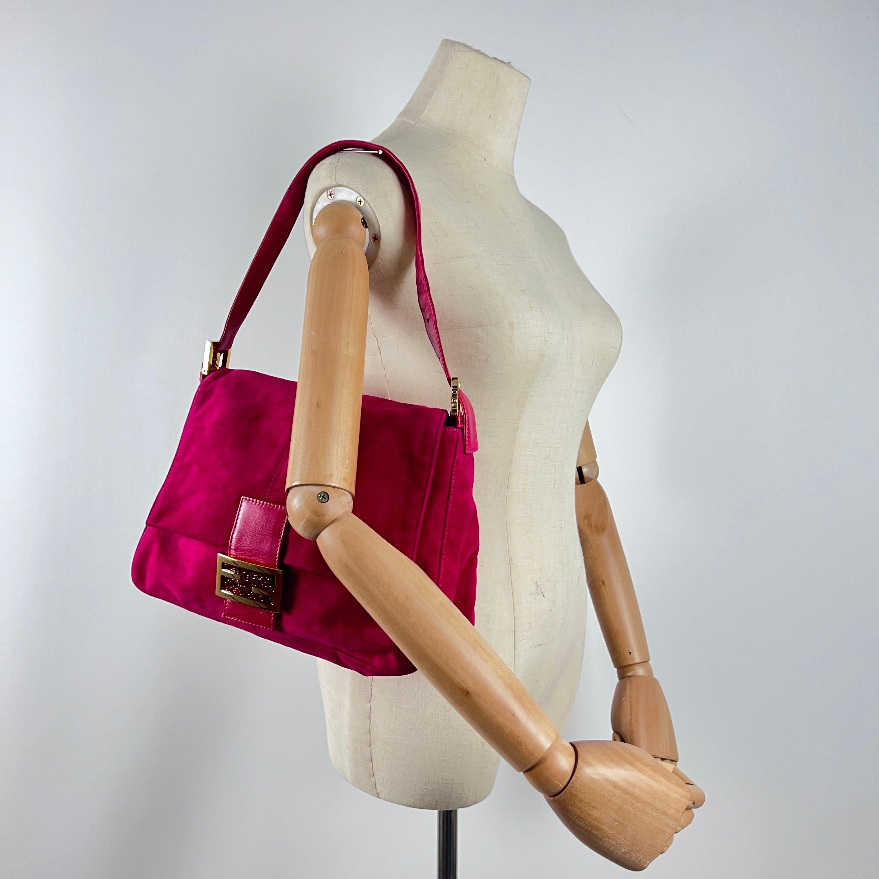Magnificent Fendi Mamma Baguette in pink suede with gold-tone hardware. Magnetic flap, lined interior with zipped pocket, and comfortable shoulder fit. A 1990s design by Silvia Venturini Fendi that embodies feminine charm and effortless