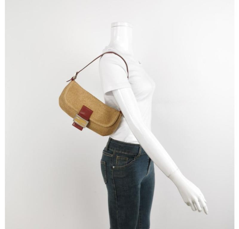 Fendi Mamma Baguette Raffia Straw Shoulder Bag Red Leather Strap
These are professional photos of the actual bag.
  
  This Fendi Baguette is made from Raffia material that‚Äôs similar to straw but softer and stronger. It is your perfect bag for a