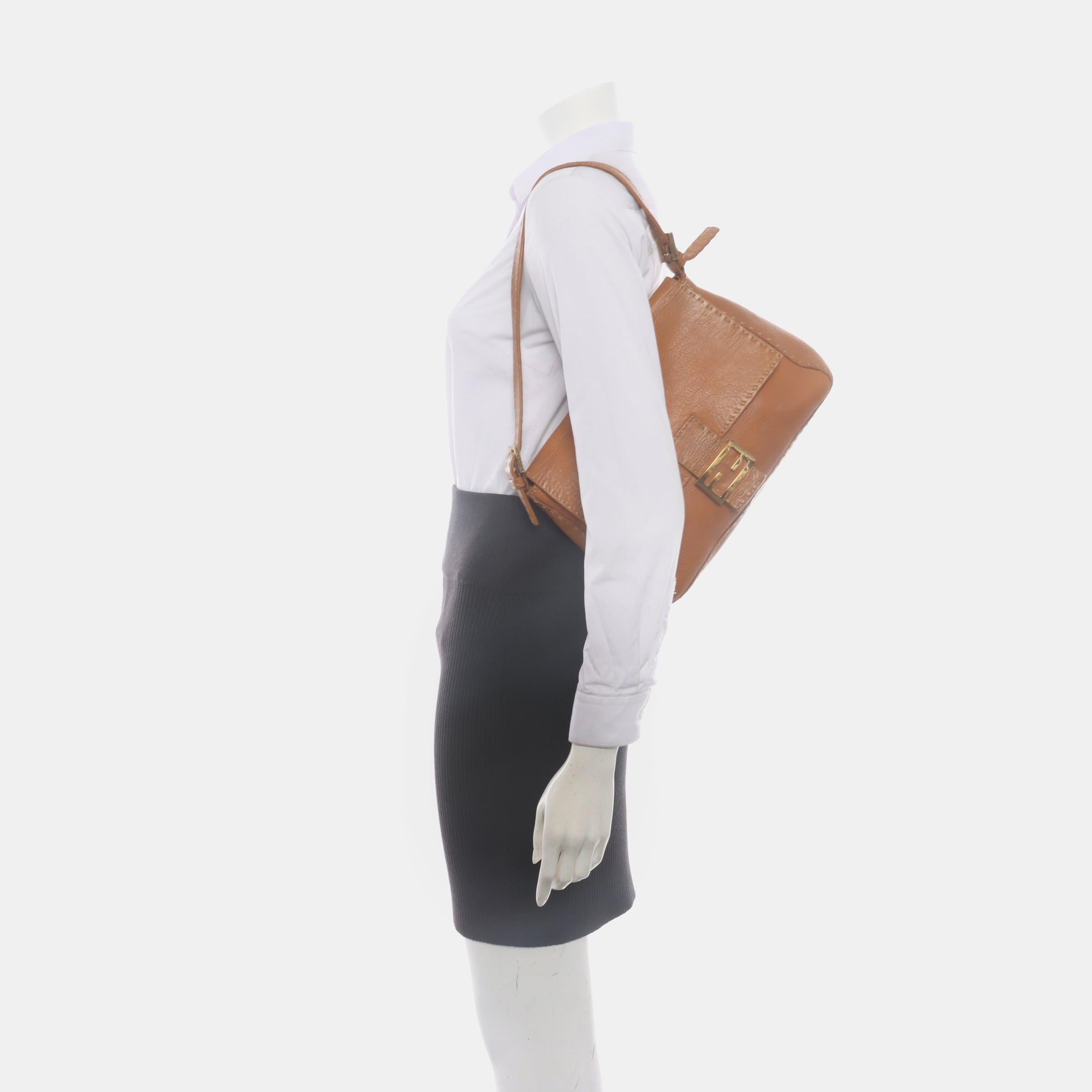 Fendi Mamma Baguette Selleria Calfskin Leather Caramel Tan Brown Shoulder Bag
 These are professional photos of the actual bag .
 Experience luxury and style with the Fendi Baguette in durable calfskin Leather Crossbody Bag. Crafted from calfskin