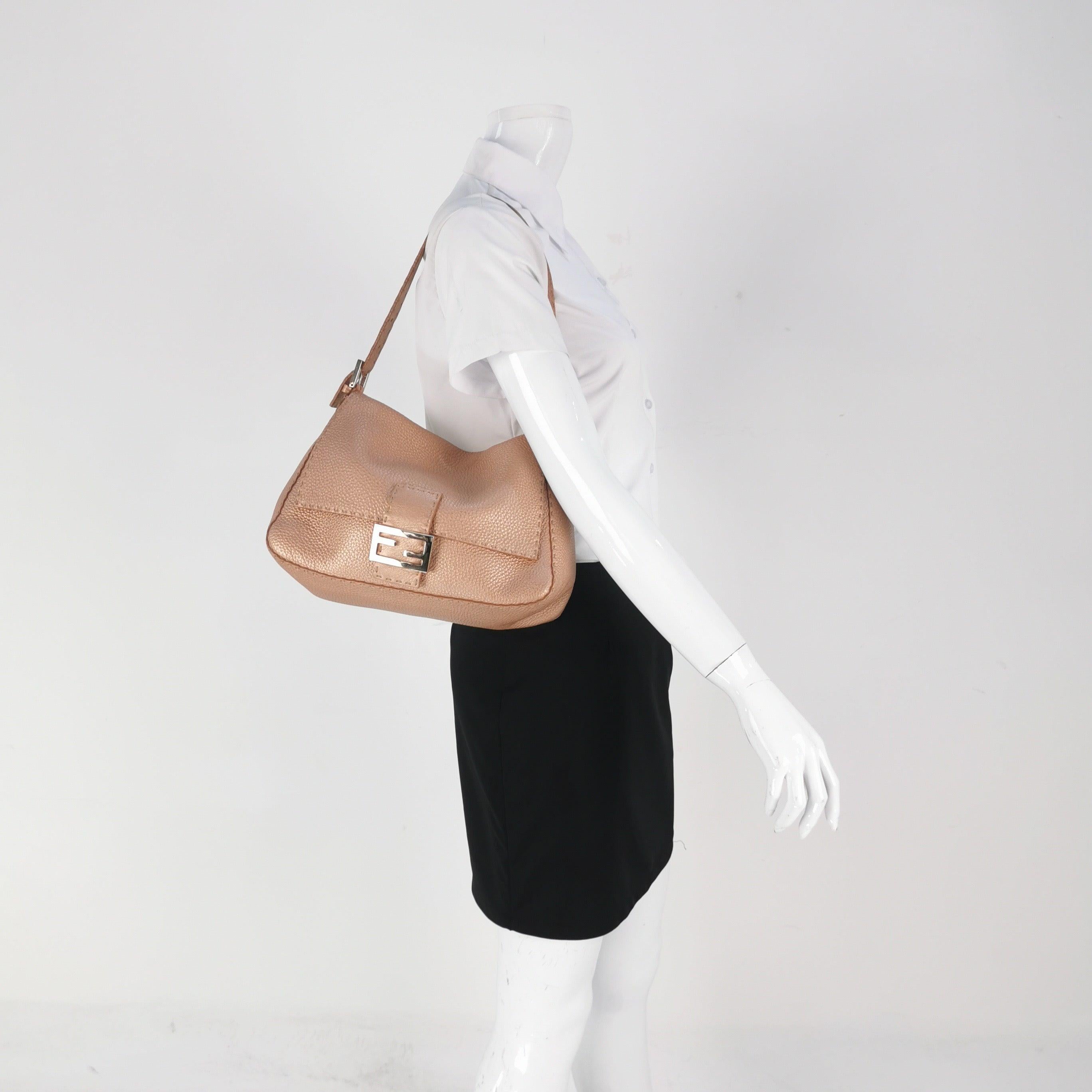 Fendi Mamma Baguette Selleria Calfskin Leather Pink Metallic Shoulder Bag
 These are professional photos of the actual bag.
 Experience luxury and style with the Fendi Baguette in durable calfskin Leather Crossbody Bag. Crafted from calfskin leather