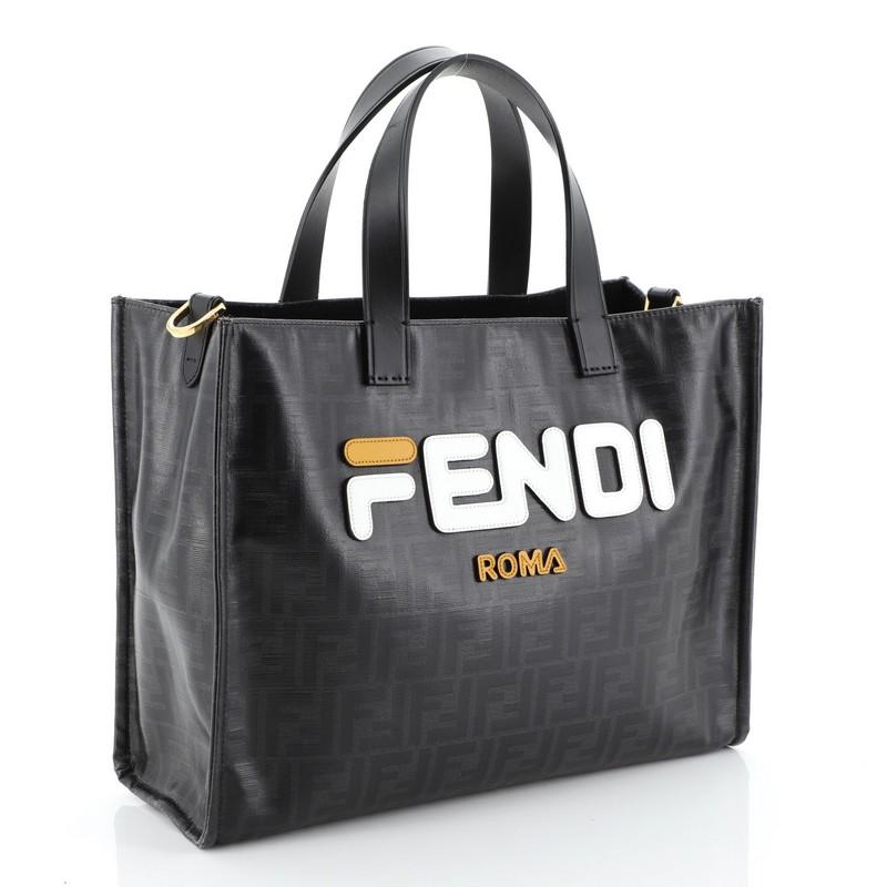 This Fendi Mania Logo Shopper Tote Zucca Coated Canvas Small, crafted from black zucca coated canvas, features dual top handles and gold-tone hardware. Its wide open top opens to a black felt interior. 

Estimated Retail Price: $1,465
Condition: