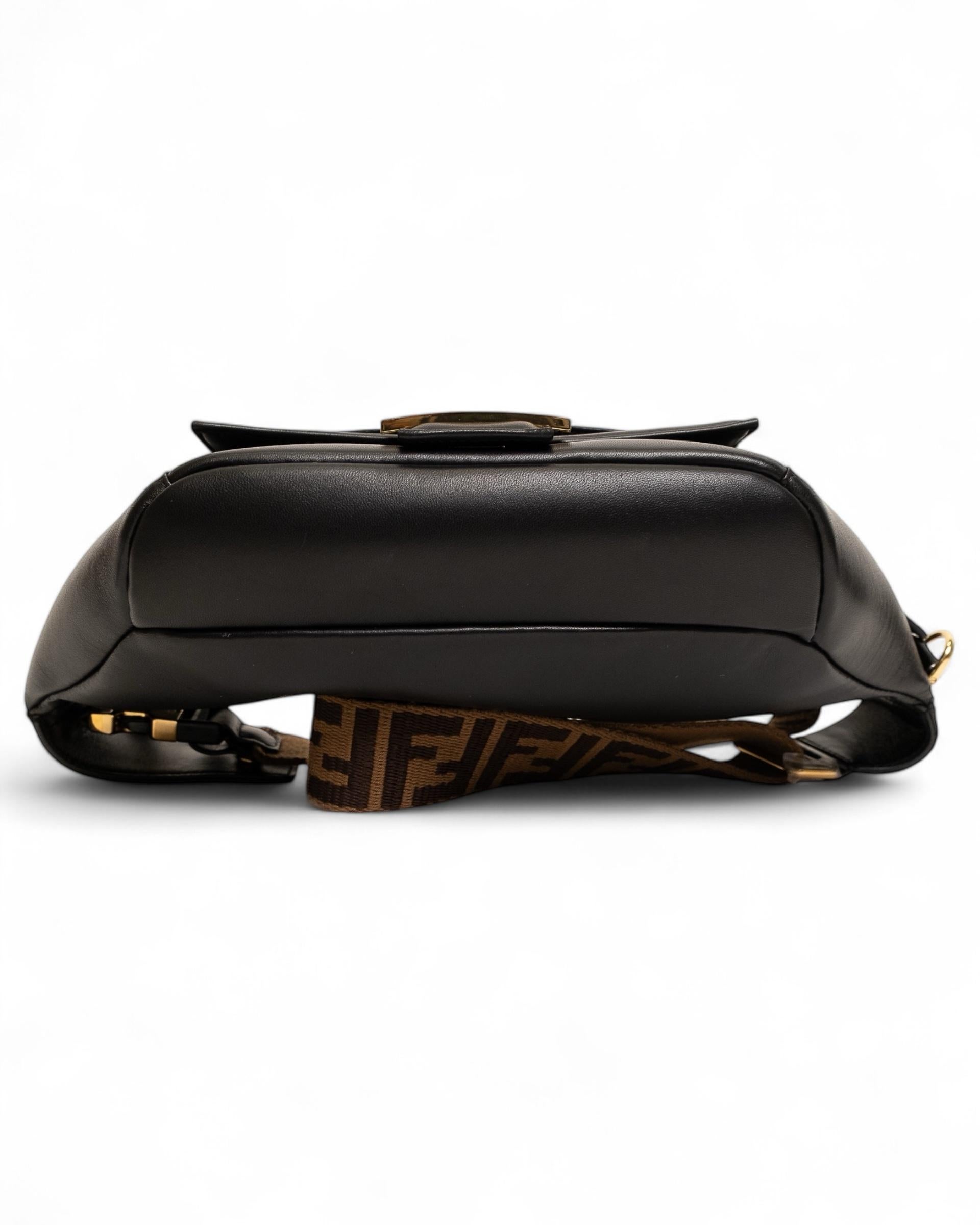 Fendi signature fanny pack, Baguette model, made of smooth black leather with gold hardware details. The double-slider front zipper closure provides convenience and security, while the tone-on-tone canvas-lined interior offers good capacity.