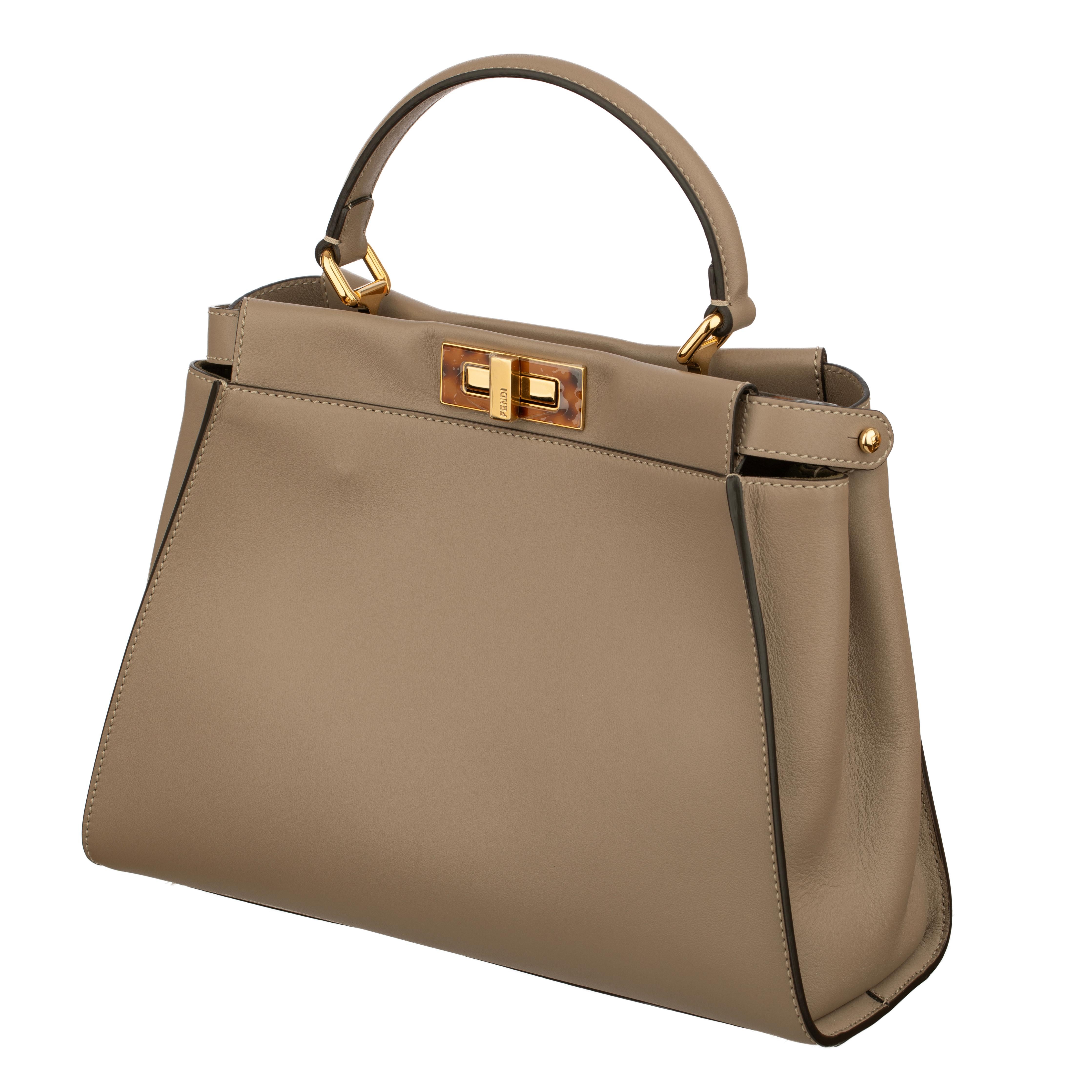 Brand: Fendi

Product: Medium Peekaboo Bag

Size: L 33 X H 26 X D 12 cm

Handle and Strap:
Top Handle Drop: 11cm
Adjustable Strap: Max Length 103cm

Colour: Taupe

Material: Calfskin leather

Hardware: Gold Tone and Tortoise

Details:	
- Single flat