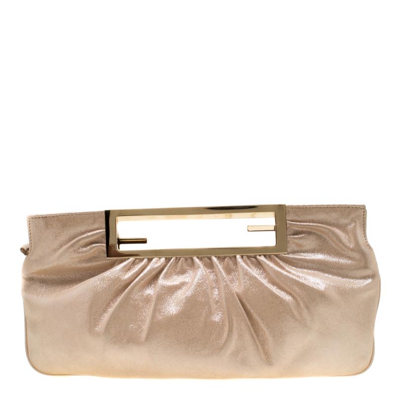 Grab this clutch by Fendi today and make a statement like never before! Crafted from metallic beige leather it features a gold-tone cut-out handle. The satin lined interior is secured by a top zip closure and sized to hold your party essentials.
