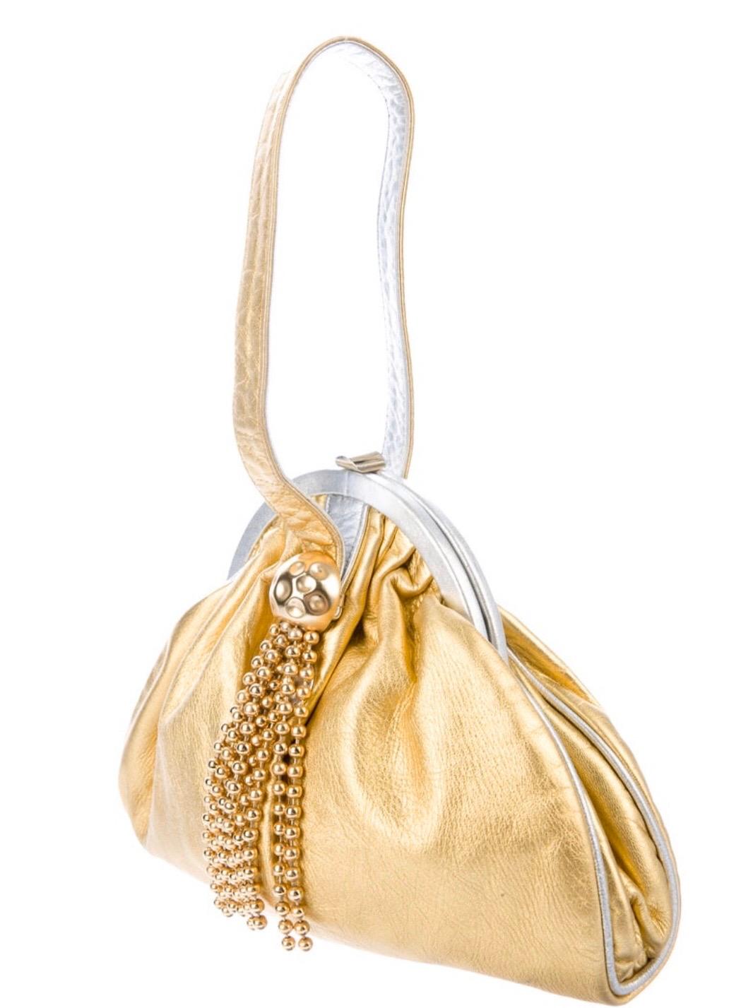 Fendi metallic gold leather evening bag with metal fringe. Silver and gold leather handle Condition: very good. 
8