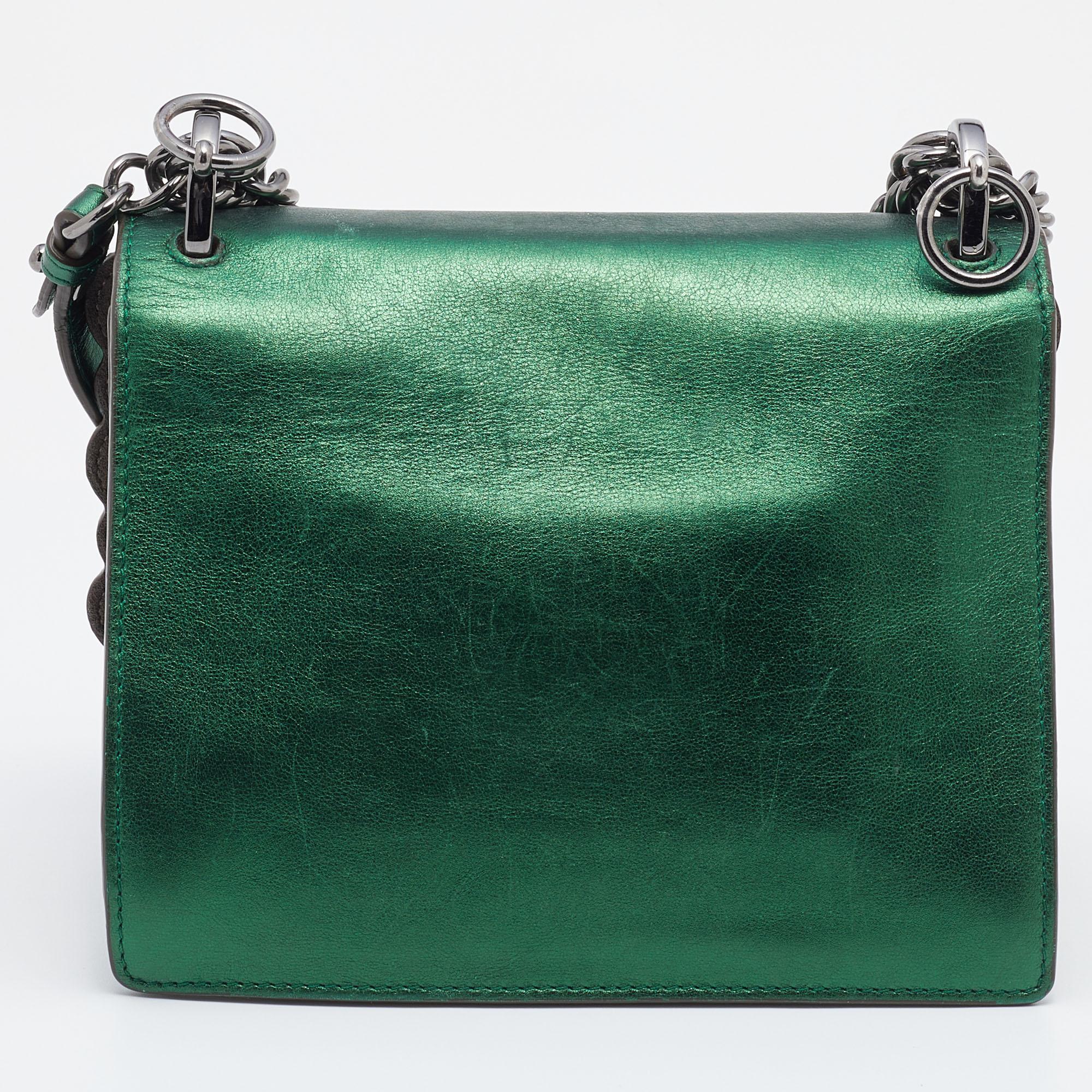 From the Resort 2017 collection, the Fendi Kan I bag depicts fun style and alluring appeal. This metallic green creation is a true piece of art with its striking details and faultless craftsmanship. Created from leather, its front scalloped trim is