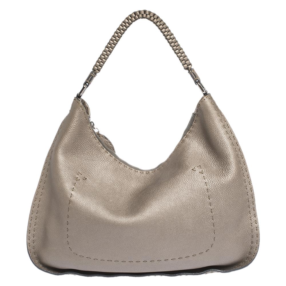 Get yourself this stunning Fendi hobo bag to showcase a fashion-forward taste. Add the right flavour to your unique fashion choice with this gorgeous metallic grey bag. A fine mix of charm and style, this quality leather bag is sure to make you