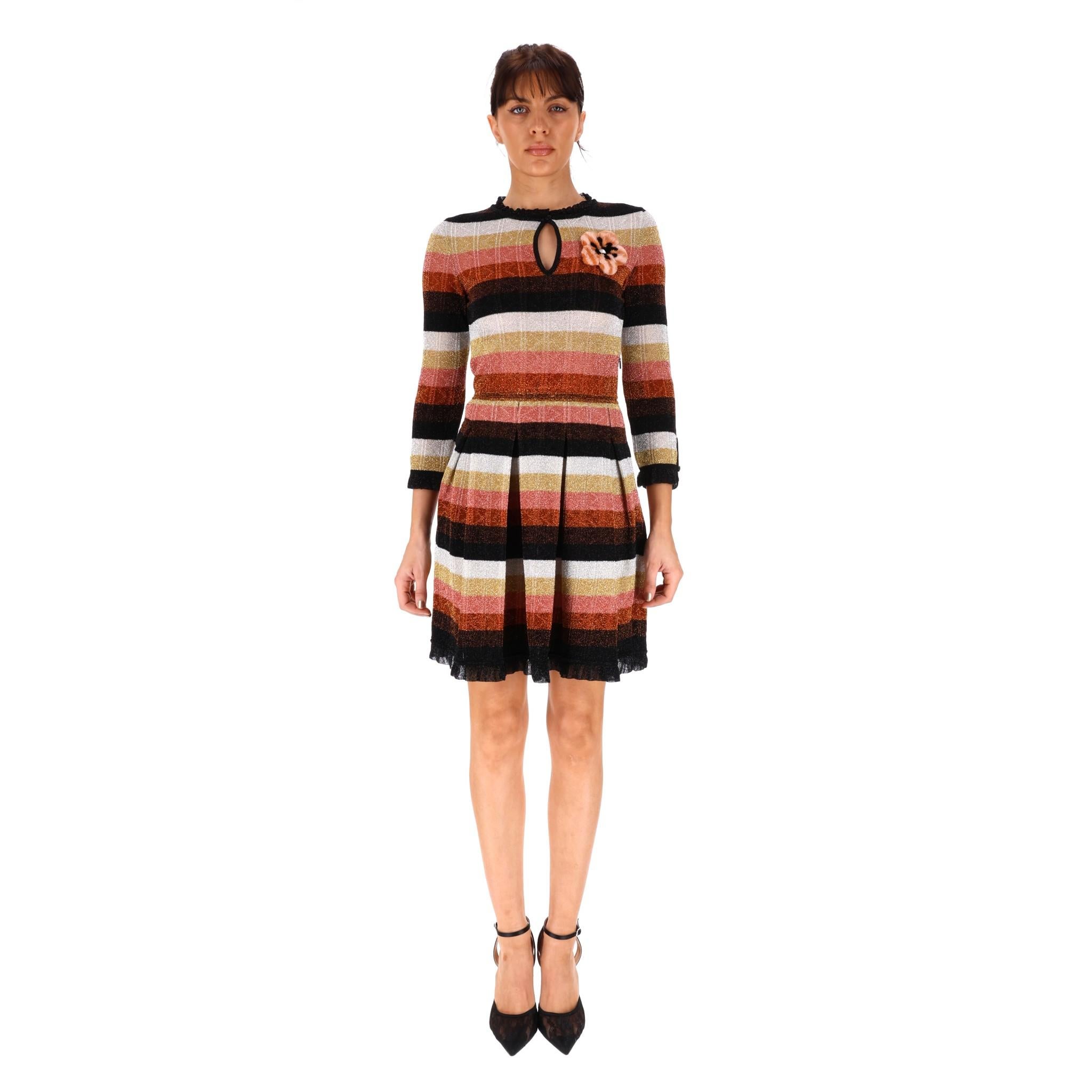 Fendi Metallic Knitted Dress With Mink Fur & Pearl Floral Adornment

Multi coloured, striped knitted dress with 3D Mink fur flower and pearl center.

Ruffled neckline and sleeves nip in at the waist, and pleated skirt,

Key hole detailing for chest