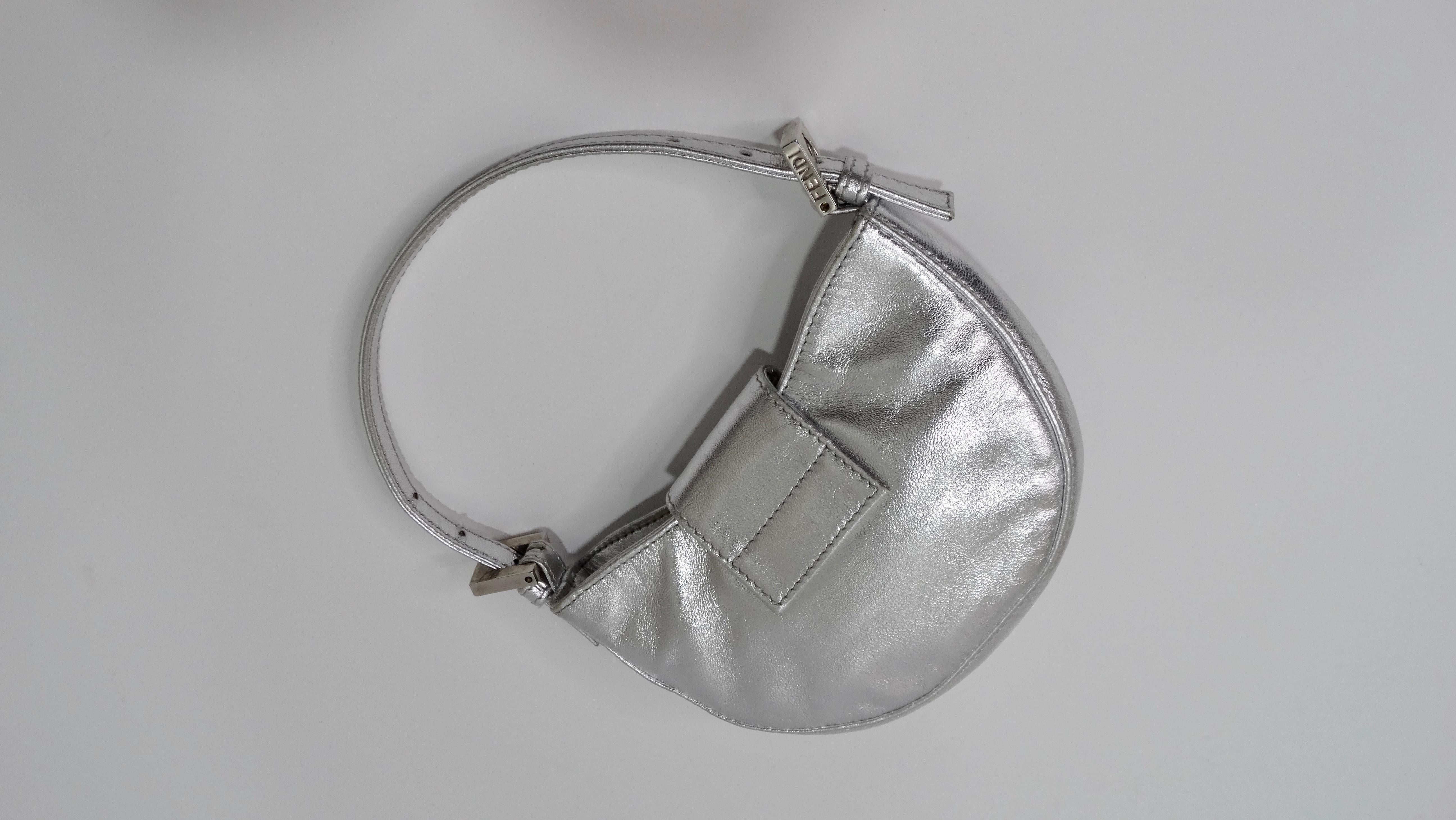 The most adorable fashion statement is about to be made with this Fendi! Circa late 1990s/early 2000s, this mini bag dubbed the 'croissant' is crafted from silver metallic leather and features a single adjustable top handle, silver hardware, and the
