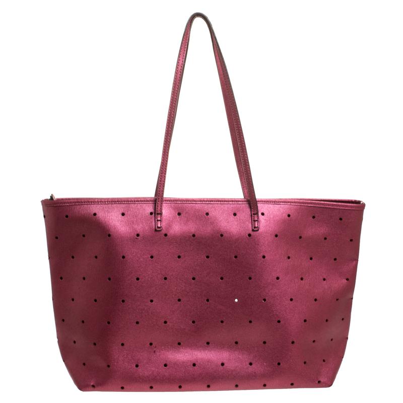 Functional and stylish, this tote is from Fendi! It has been crafted from perforated leather and designed in a metallic purple shade. The bag is held by two handles and is equipped with a spacious suede interior capable of holding all your
