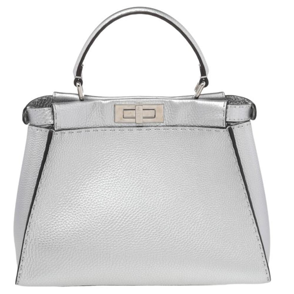 This exquisite Peekaboo from Fendi is highly coveted, and since its birth in 2009, it has swayed us with its shape, design, and beauty. This version comes meticulously crafted from leather and designed with a top handle for you to swing it. A twist