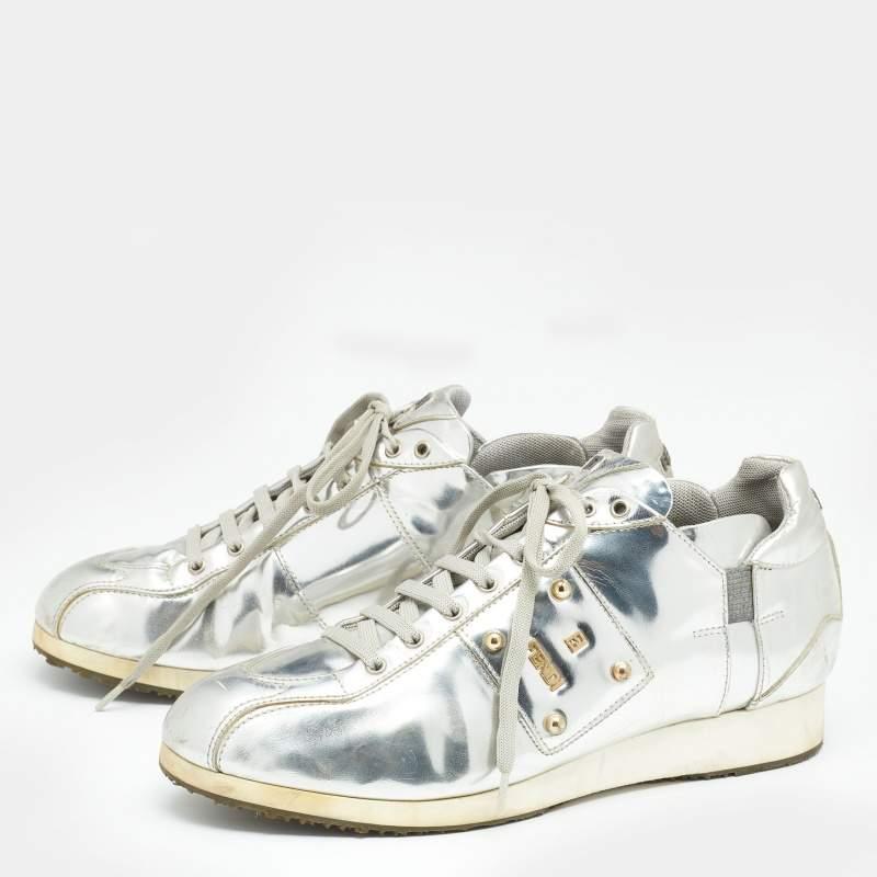 These Fendi sneakers are an apt choice for a statement look. Created from metallic silver patent leather, they are teamed with lace-up vamps, rubber soles, and fabric insoles. The brand signature on the sides, tongue, and counter adds an exclusive