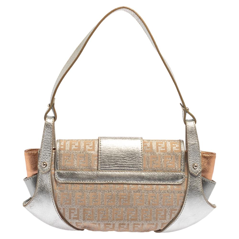 This Borsa Tuc bag from Fendi is styled in the most covetable silhouette. It is crafted with a combination of Zucchino canvas and leather accents in metallic silver featuring a flap top with push-lock closure. The interior of the handbag is lined in