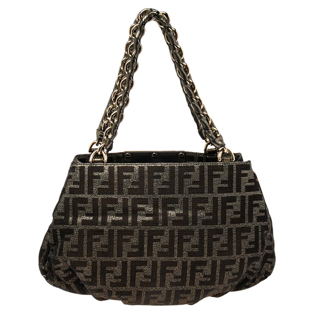 An effortlessly chic classic Fendi creation, this small Mia tote will definitely be your everyday bag. It features Fendi's signature Tobacco Zucca canvas on the exterior with a gold-toned FF accent on the front and woven chain straps added to its