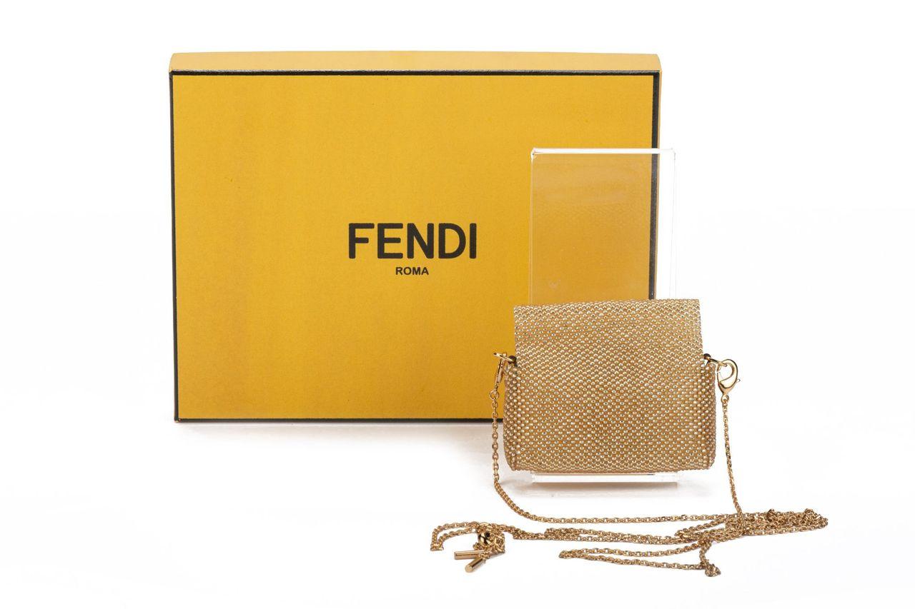 Fendi micro baguette made of weaven gold steel. On front is the typical F logo clasp to close the bag. The piece comes with a adjustable and detachable shoulderbag (23”). The piece is new and comes with a box and dustcover.