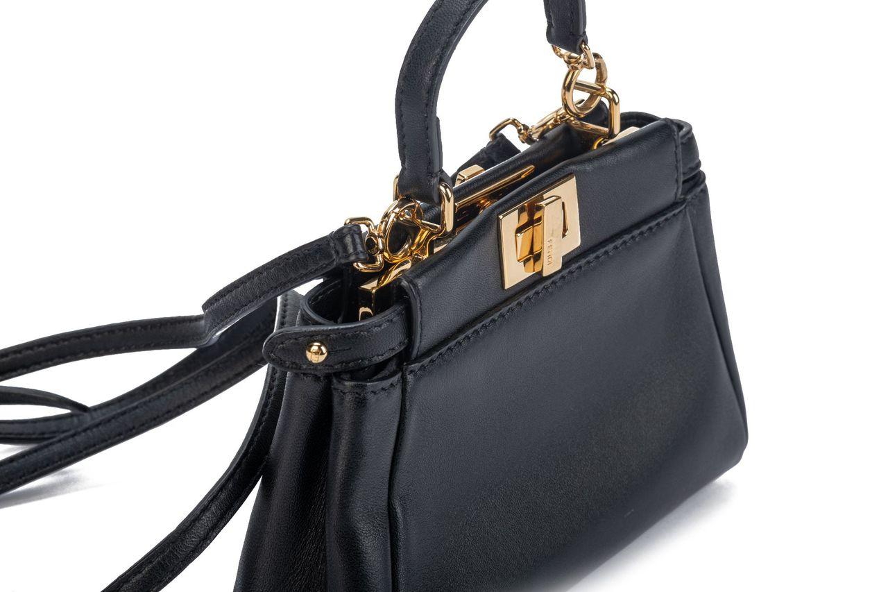 Fendi Micro Peekaboo bag in black. The hardware is gold and it comes with a shoulder strap (24