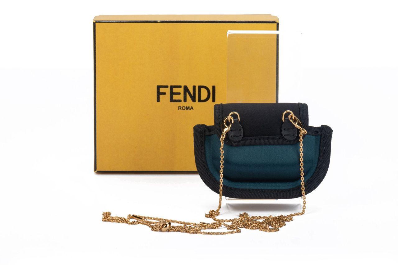 Fendi micro necklace bag crafted of leather in a petrol green. The bag can be worn as a shoulder bag with the adjustable and detachable chain (23