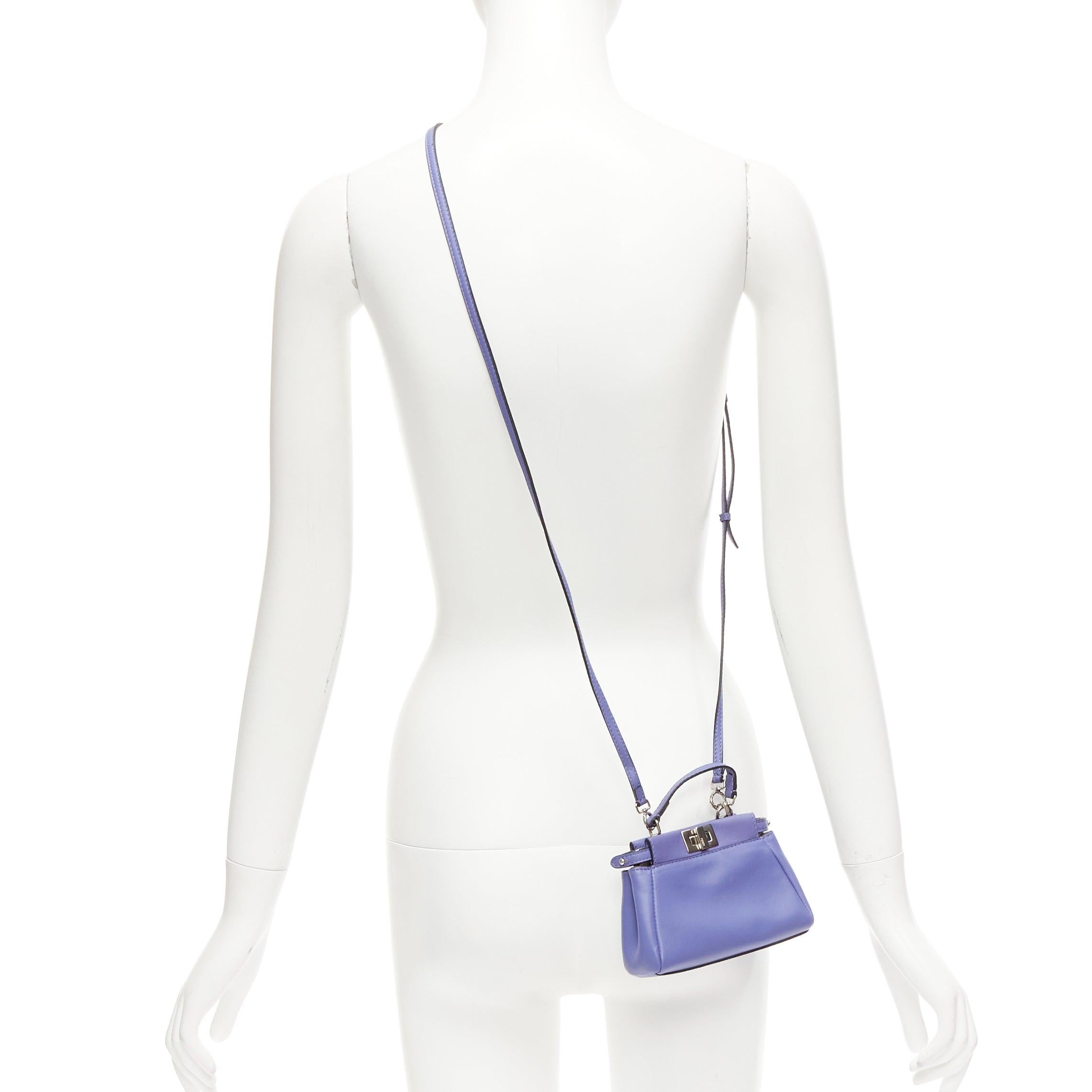FENDI Micro Peekaboo purple leather turnlock mini crossbody satchel bag
Reference: LNKO/A02356
Brand: Fendi
Model: Peekaboo Micro
Material: Leather
Color: Purple, Silver
Pattern: Solid
Closure: Turnlock
Lining: Grey Leather
Extra Details: Purple