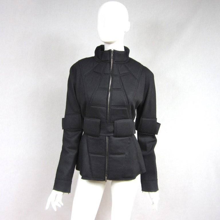 Very Mad Max. Black Quilting front and back, This is not a heavy jacket it is lightweight great for spring and Fall. Zippers up from the bottom as well as the top. Large oversize belt closure that snaps shut and zippered sleeves.  Ready to Wear
