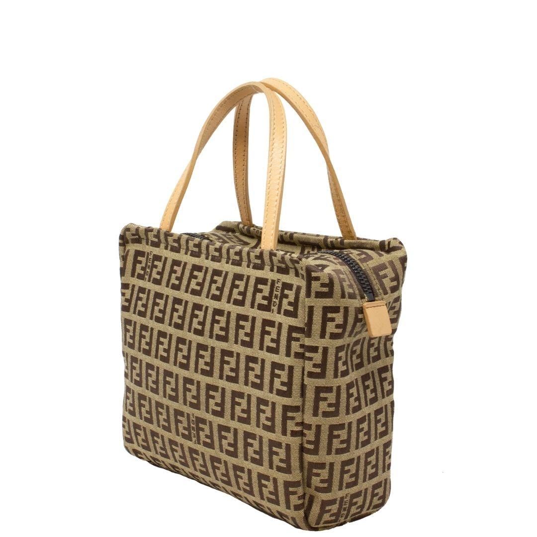 Super cute beige mini Fendi crafted in beige Zucchino canvas with two thin creme leather handles. The top zipper opens up to a brown canvas interior. Perfect sihlouette!

SPECIFICS
Length: 7